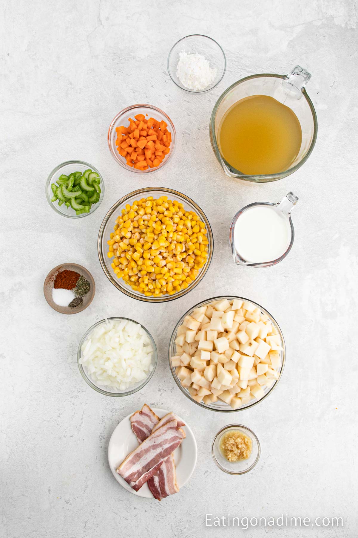 Potato Corn Chowder Ingredients - bacon, onion, carrot, garlic, salt, pepper, paprika, thyme, chicken broth, potatoes, corn, cornstarch, cheese, green onions