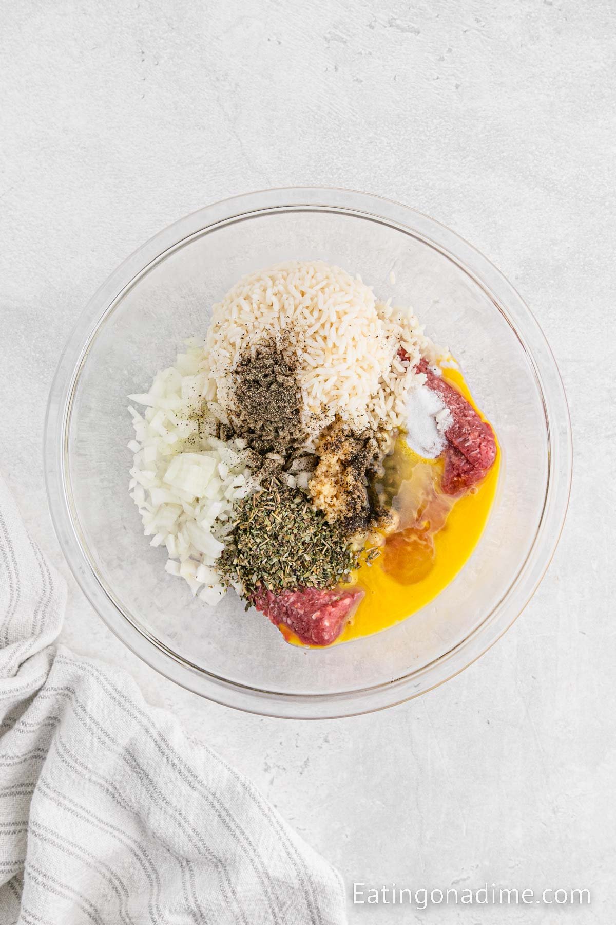 Combining the meat mixture ingredients in a bowl