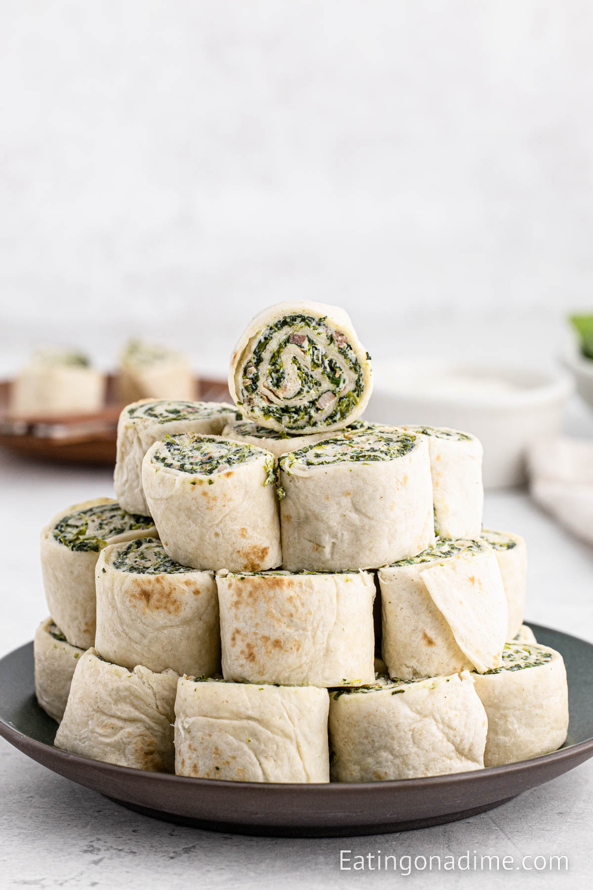 Spinach Roll Ups stacked on a plate