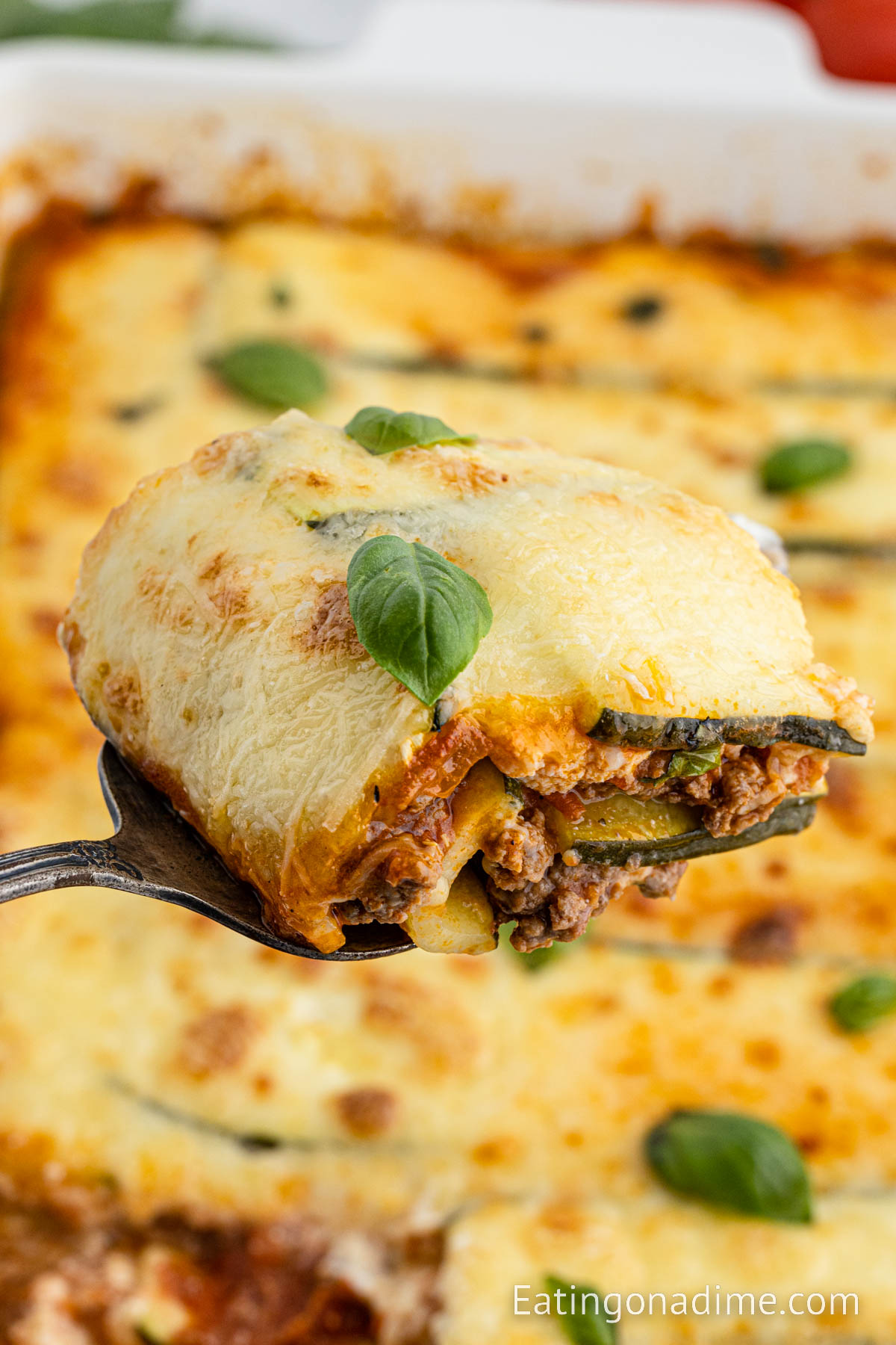 Close up image of a serving of zucchini lasagna on a spatula