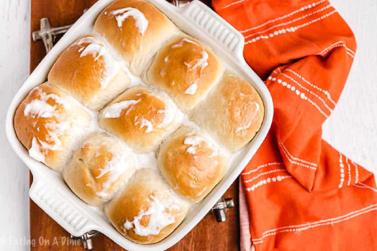 You are going to love this Kings Hawaiian Rolls Recipe. It is so easy to make and tastes just like the real thing. Save money and make Kings Hawaiian rolls. King's Hawaiian Rolls in a 8x8 baking dish topped with melted butter.