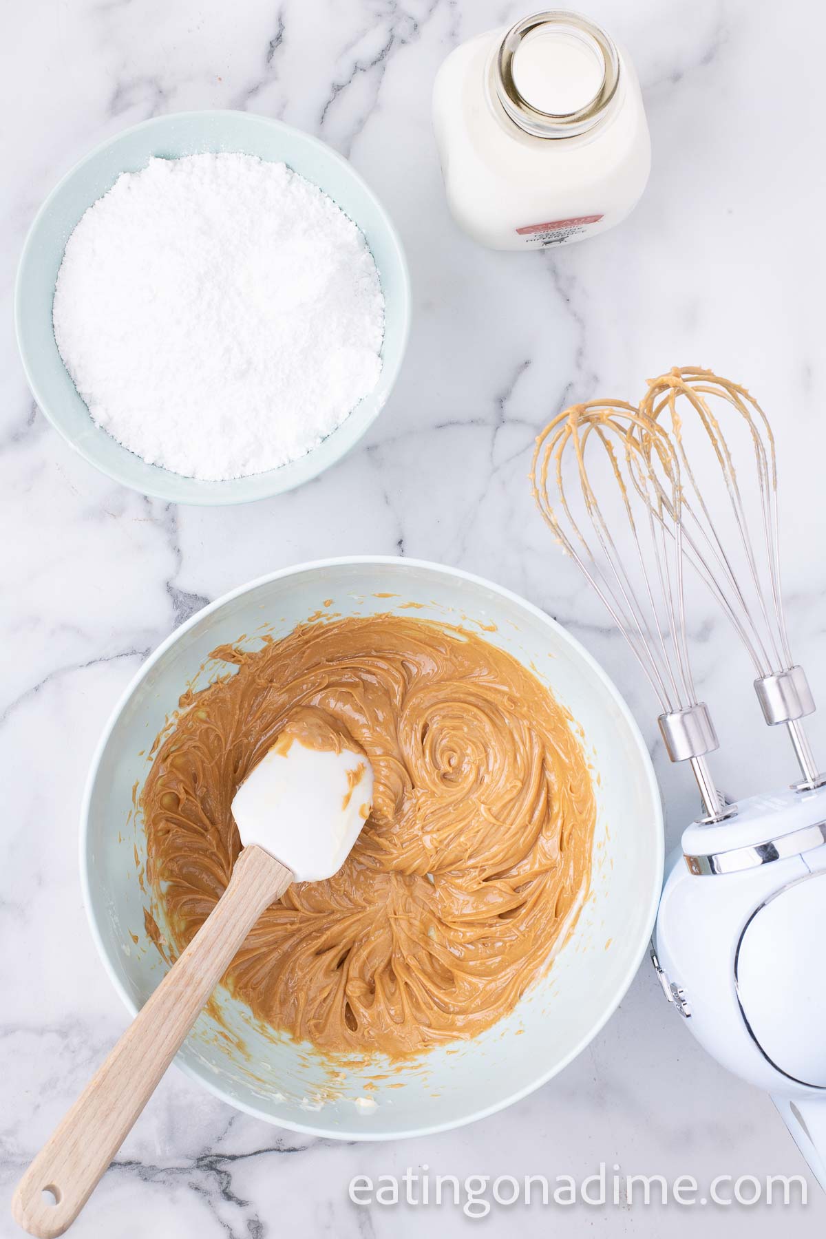 Beating powdered sugar into the peanut butter mixture