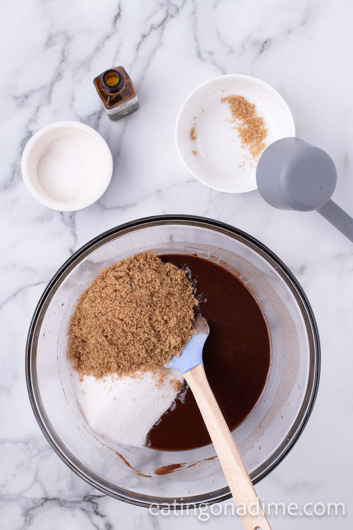 Sugar, brown sugar, and vanilla extract in a bowl