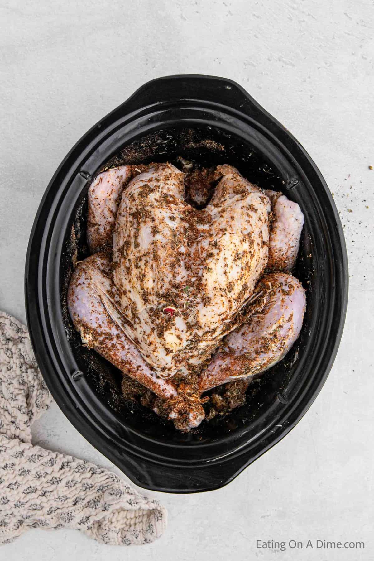 Placing the whole turkey in the slow cooker