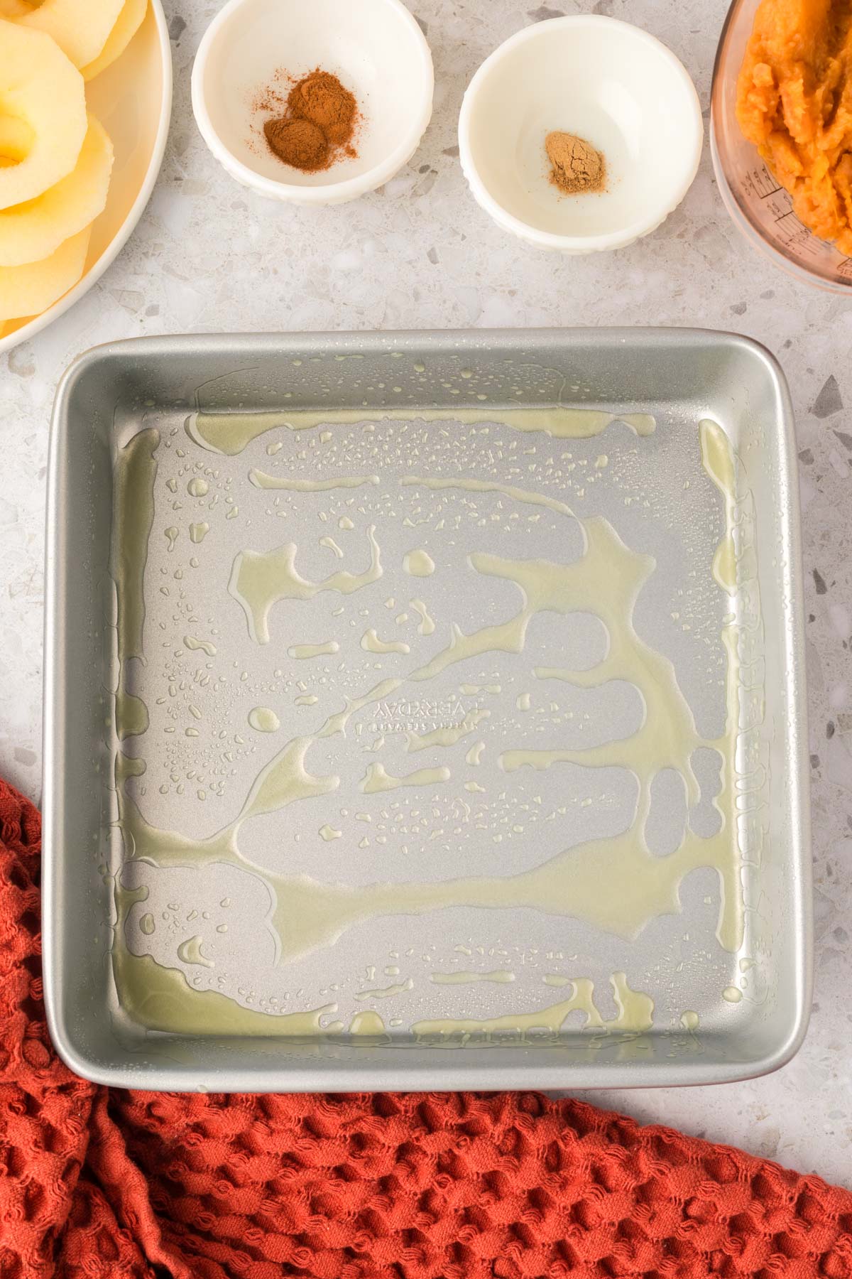 Preparing the baking dish with cooking spray
