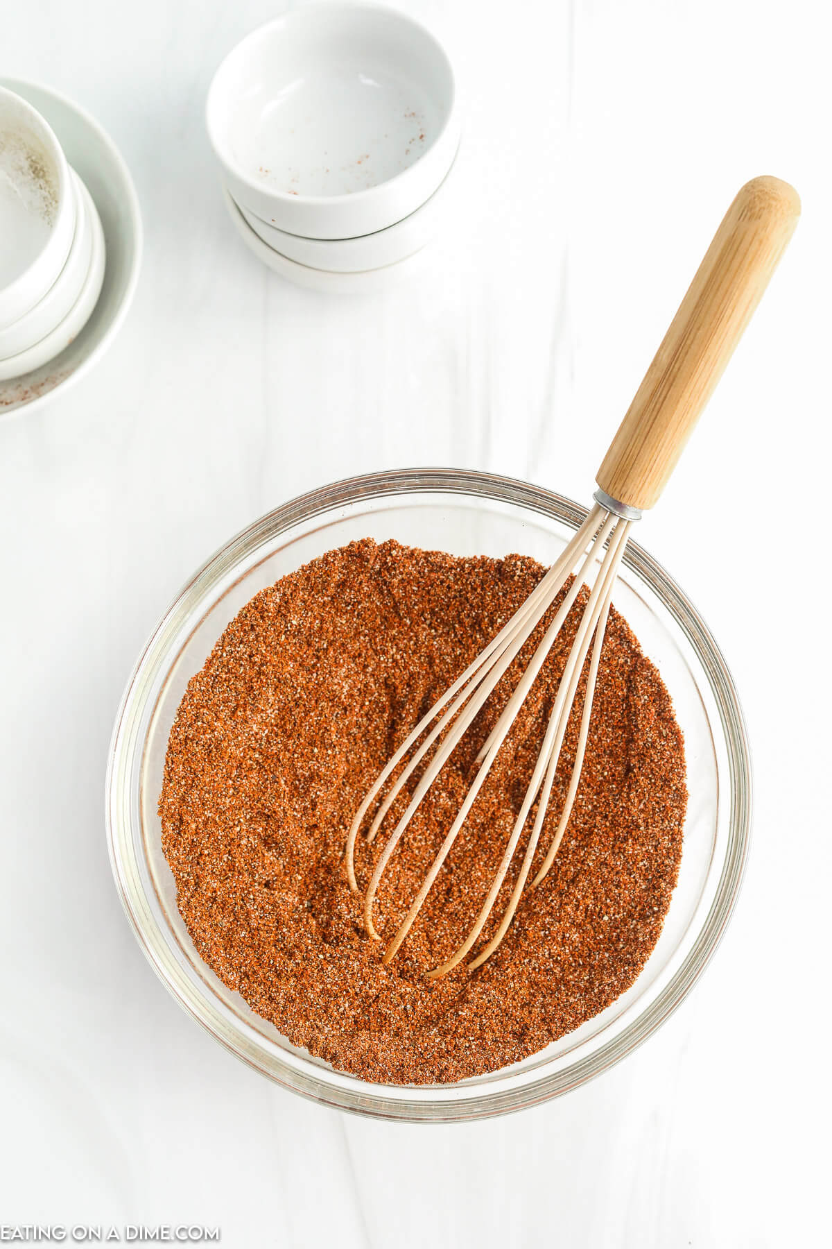 Combined chili seasoning in a bowl with a whisk