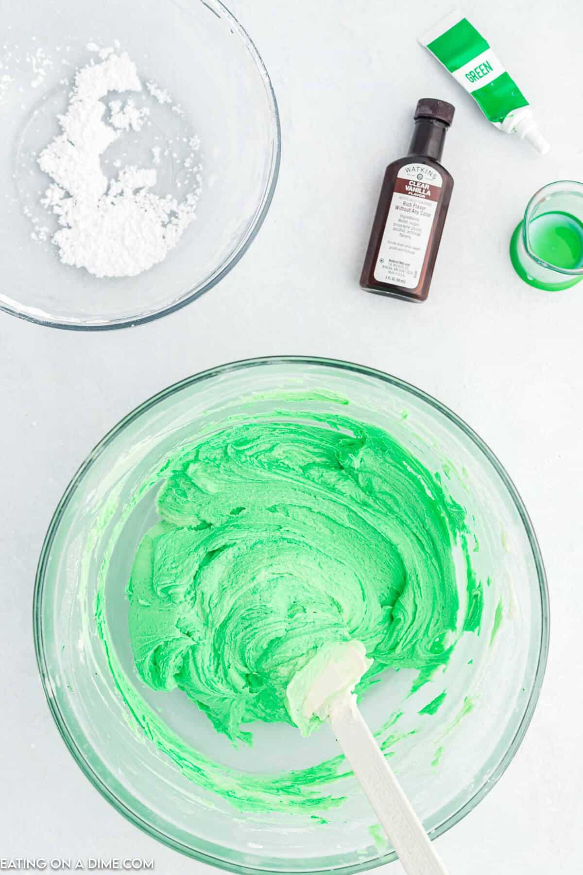 Green food coloring added to mixing bowl. 