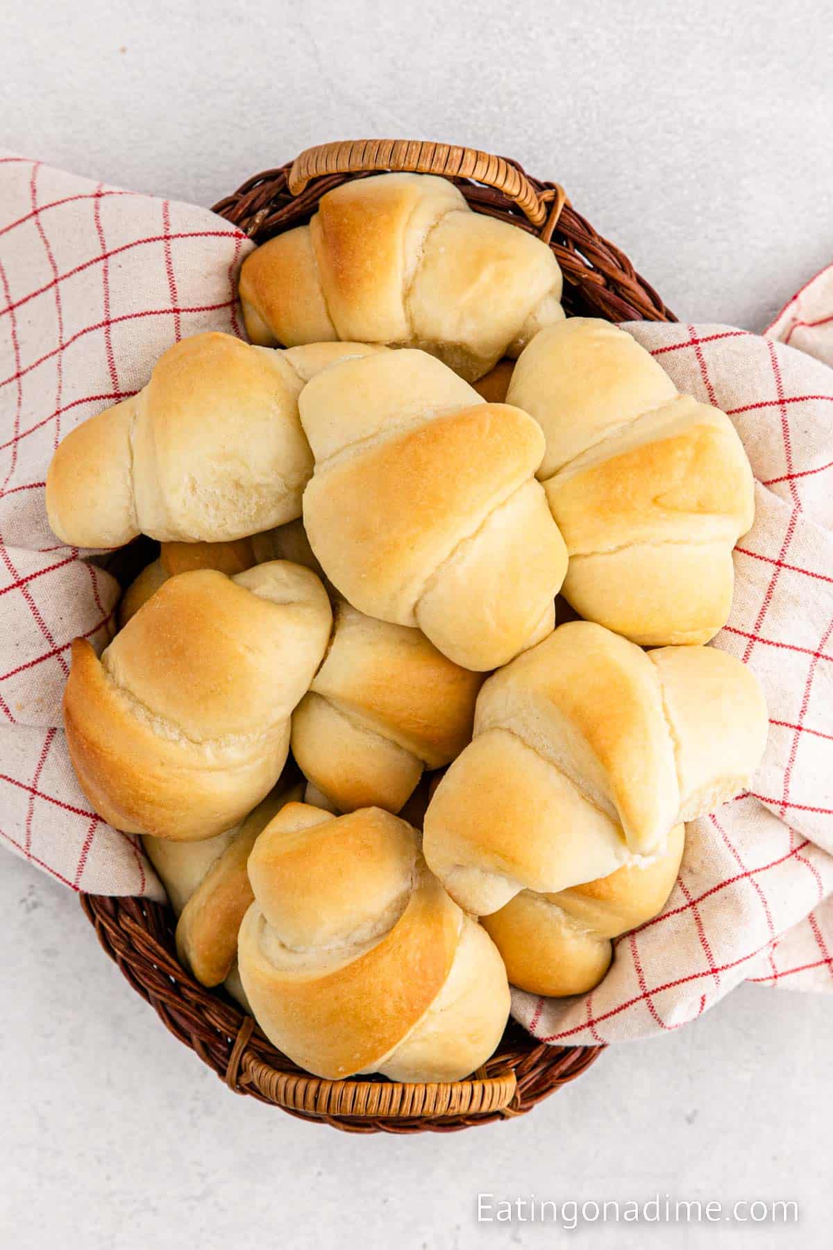 Close up image of crescent rolls stacked in a basket