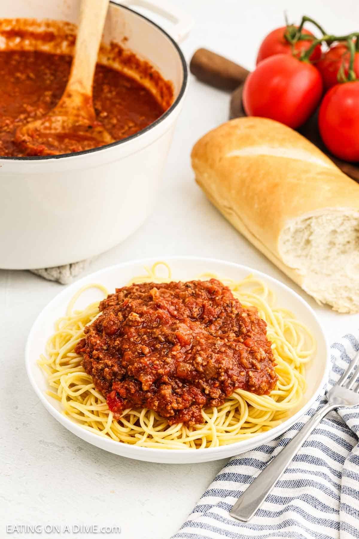 Meat sauce on a plate with spaghetti noodles.