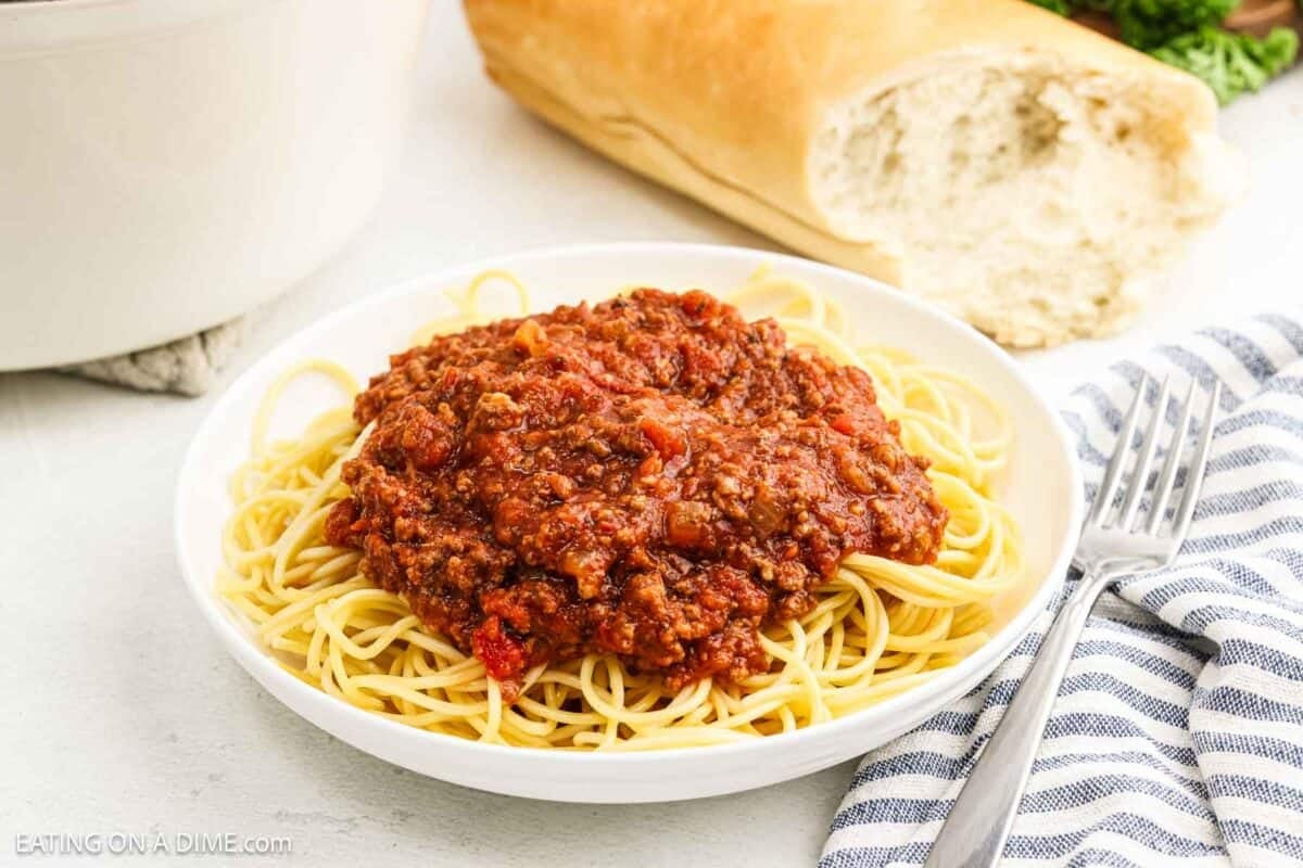 Meat sauce on spaghetti on a plate.