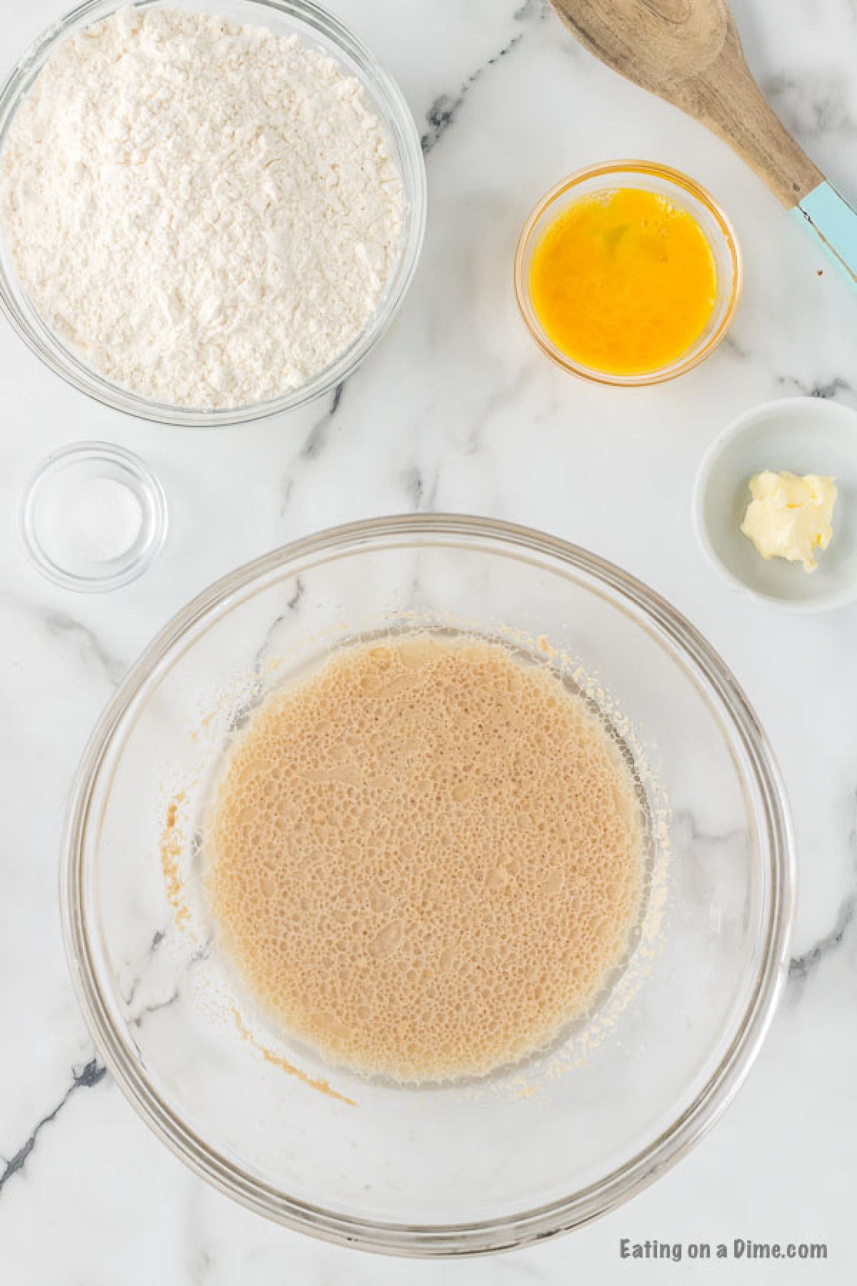 Mix together water, oil, sugar, and yeast in a bowl