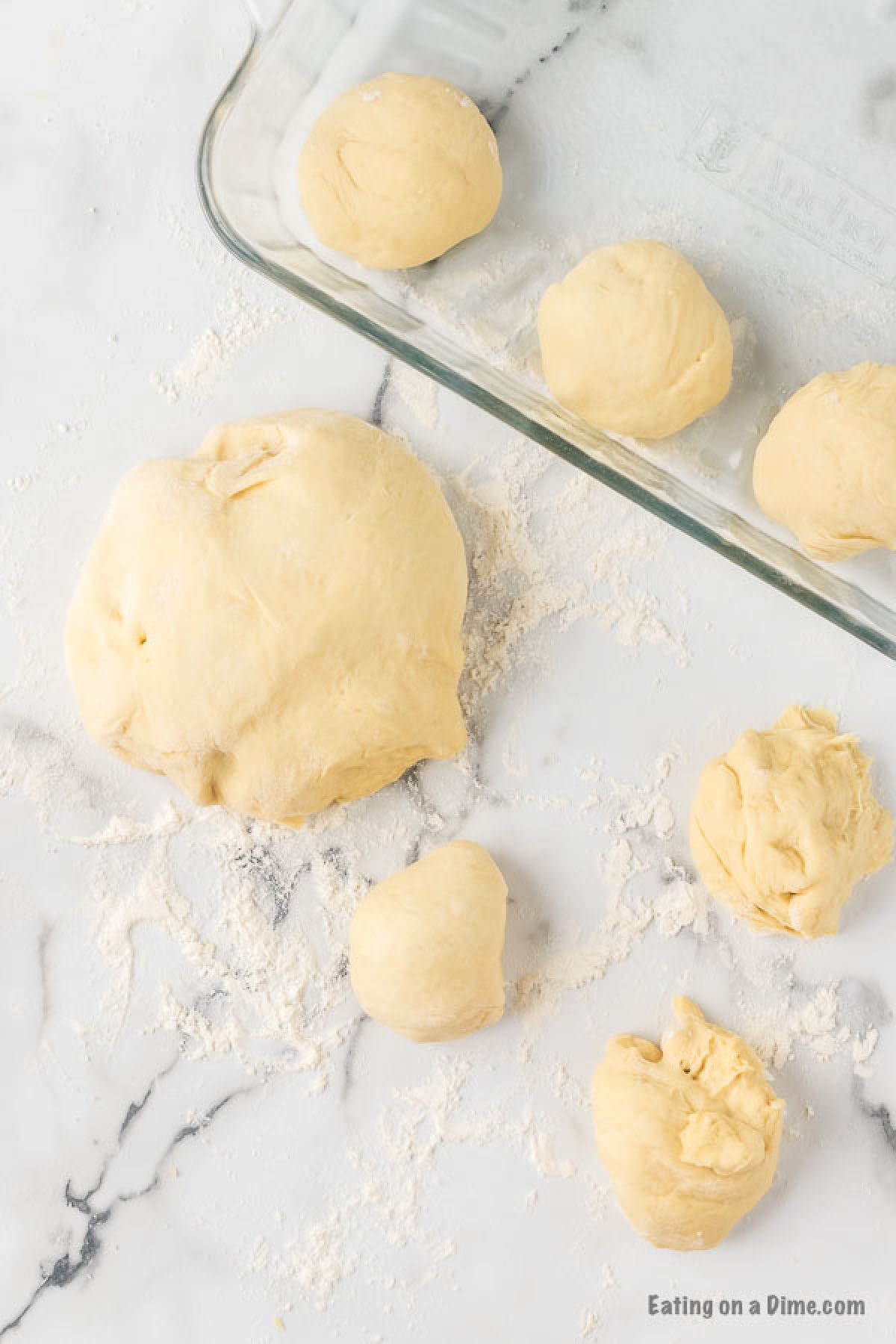 Making the dough into 12 balls and placing in a prepared baking dish