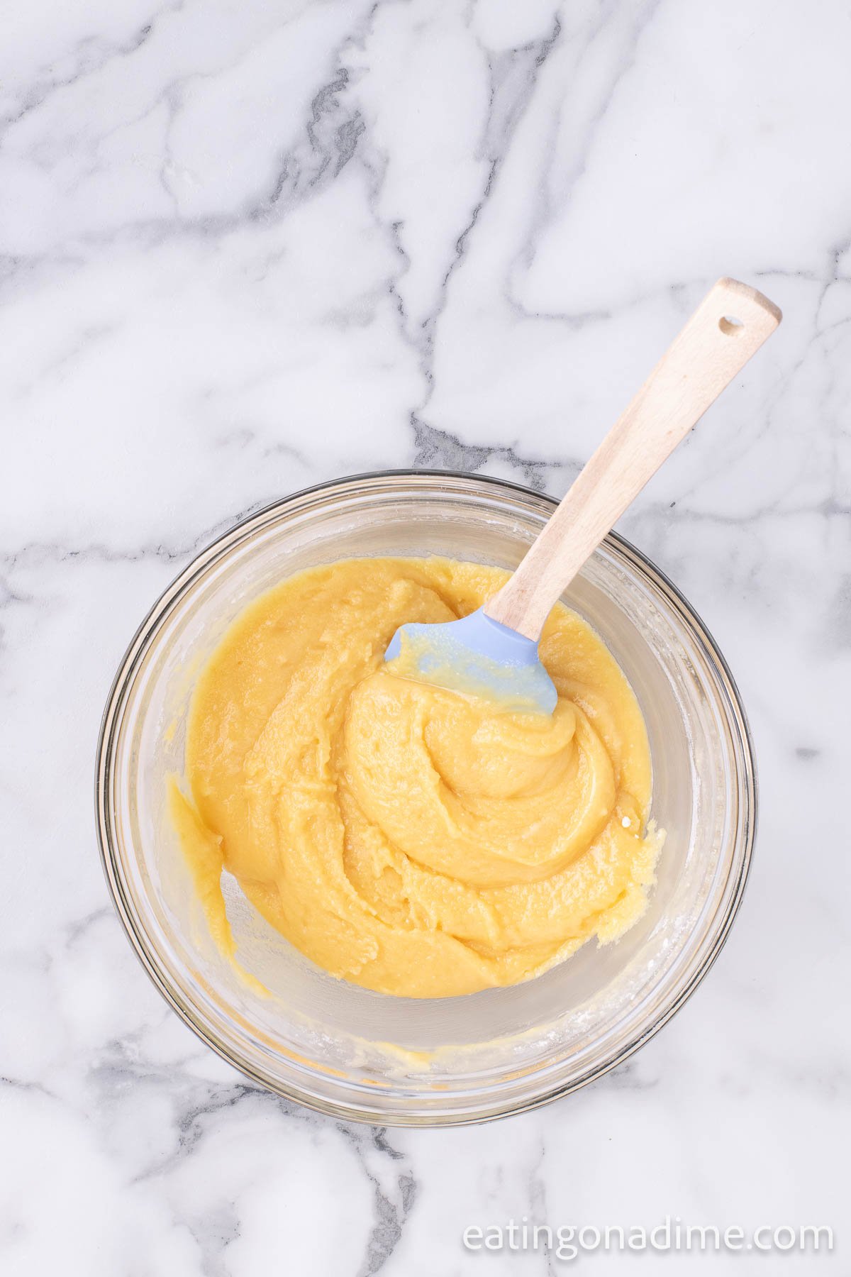 Combining the cake mix with melted butter in a bowl