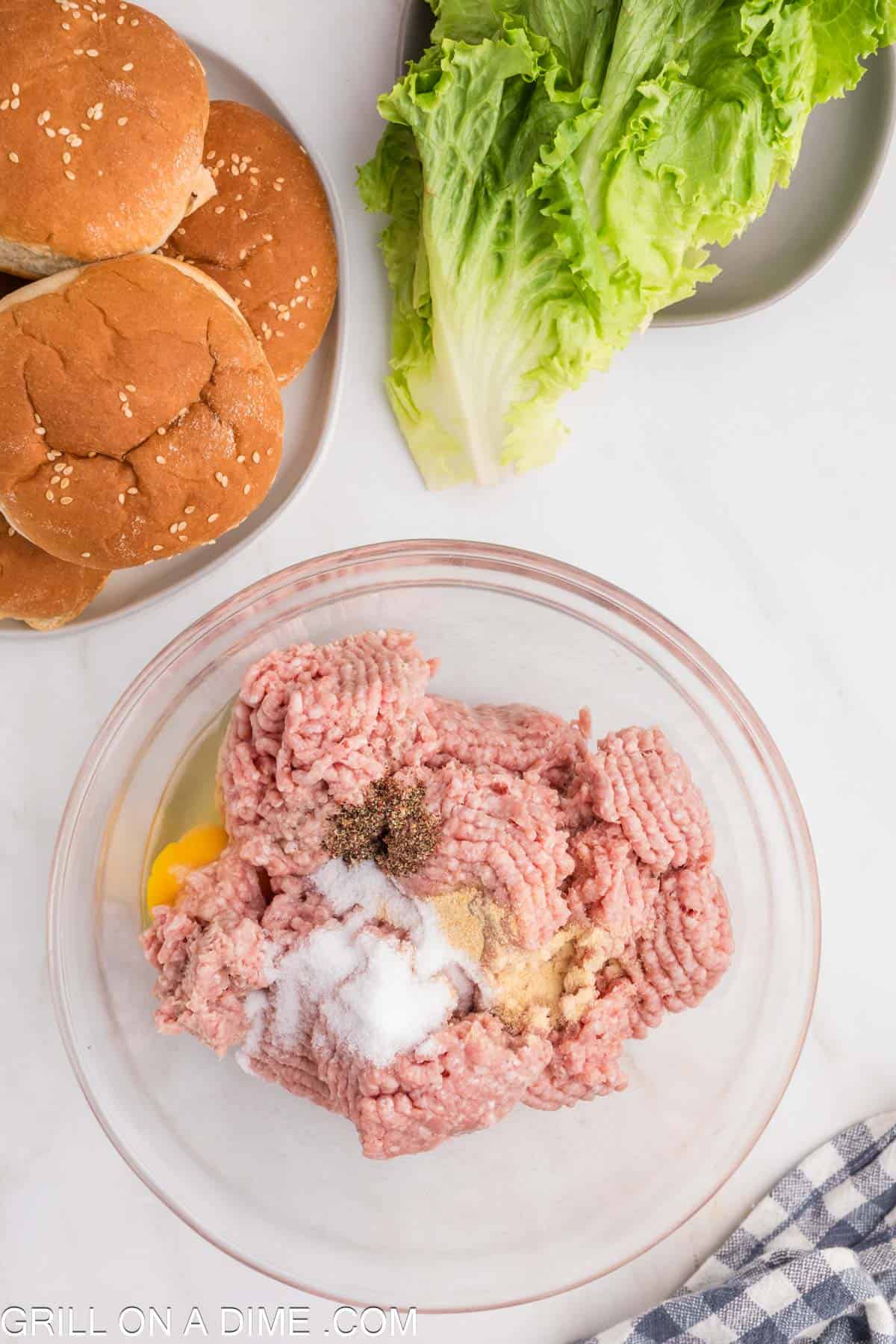 Ground turkey in a bowl topped with egg and seasoning