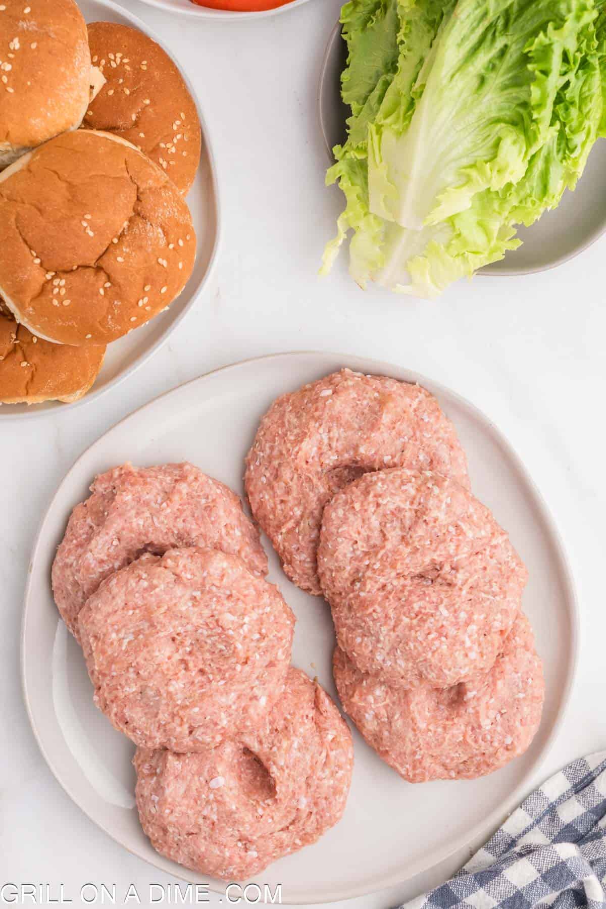 Ground turkey patties stacked on a plate