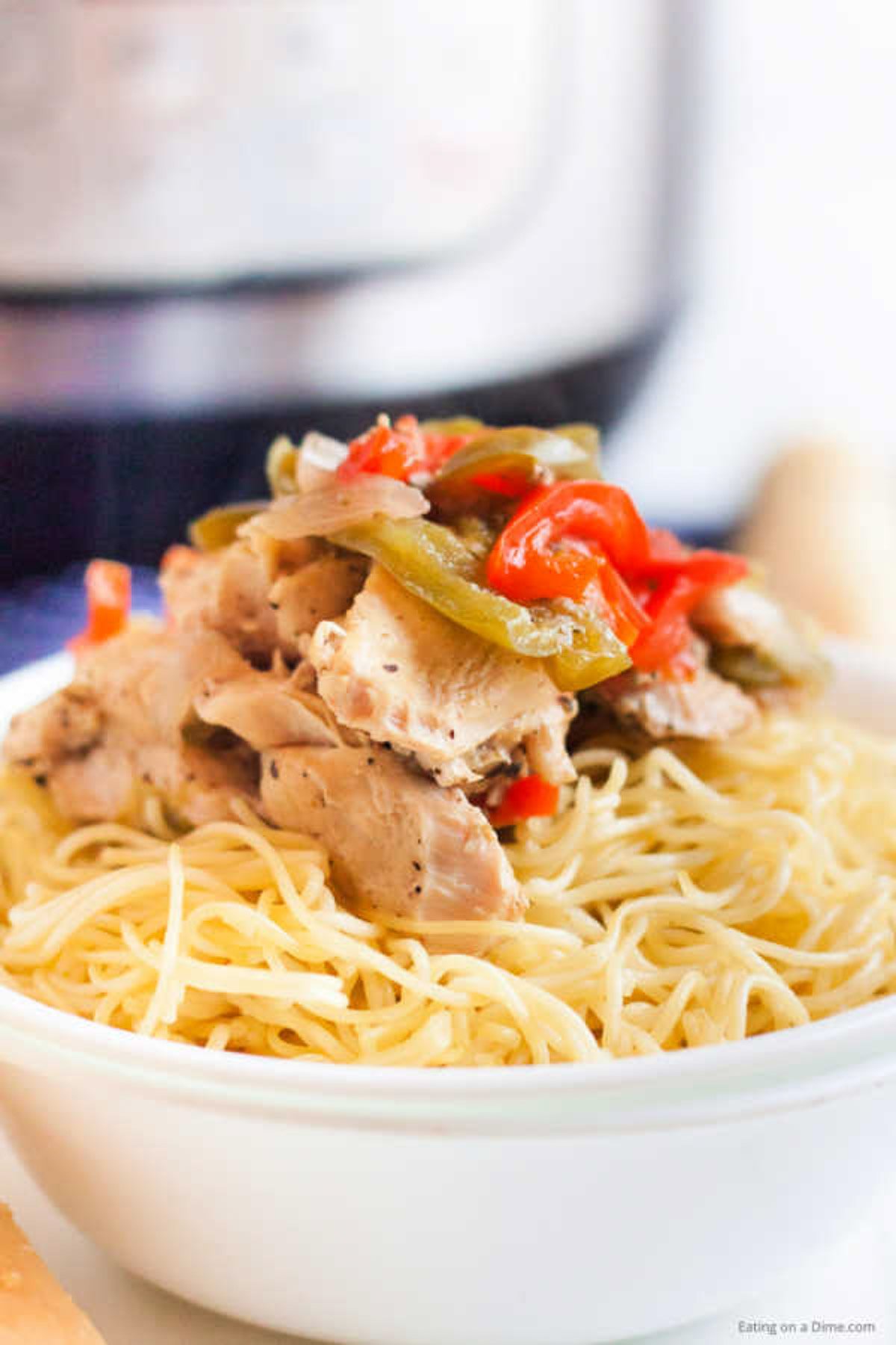 Close up image of a bowl of chicken scampi over pasta. 