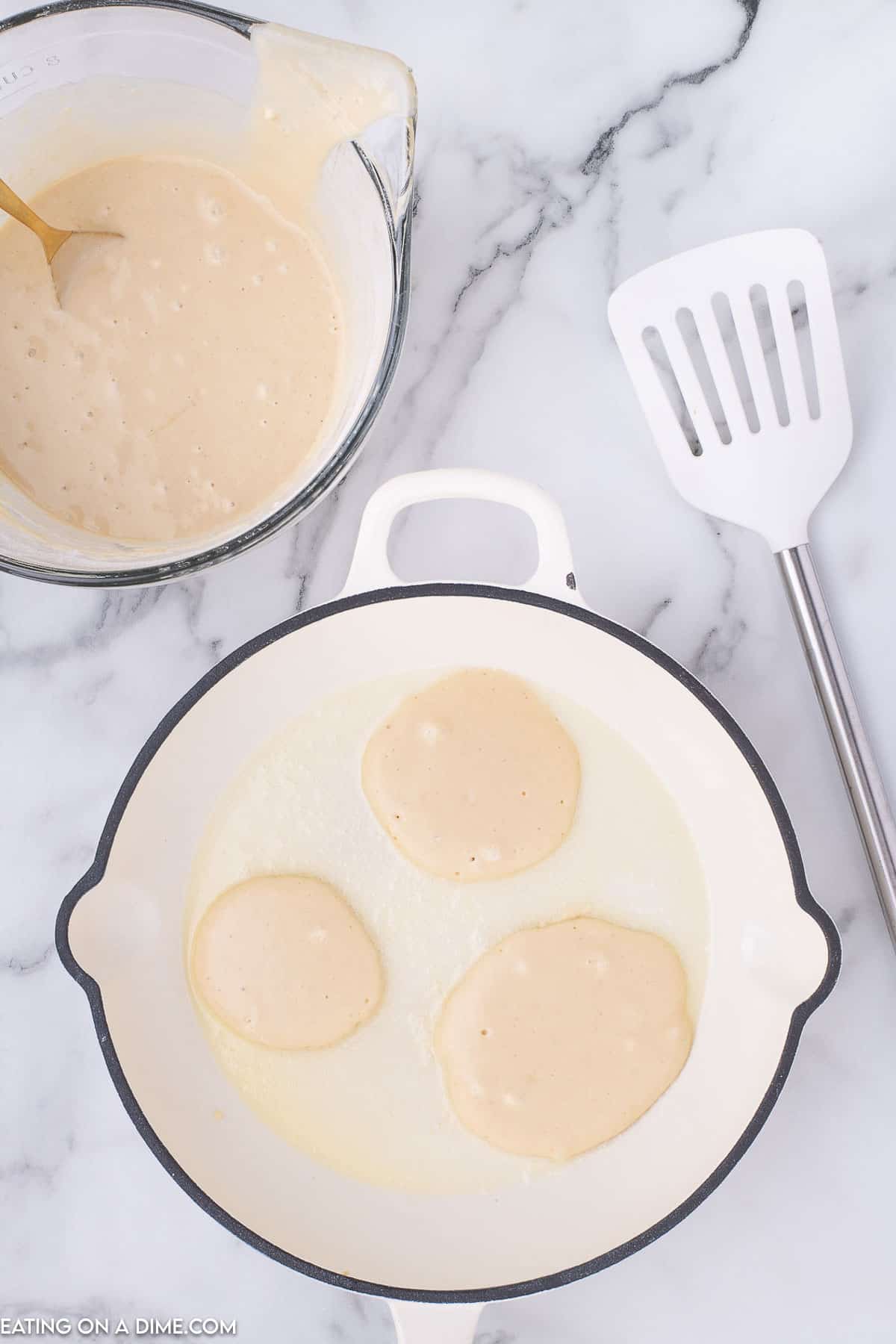Pouring batter into round circles on a skillet