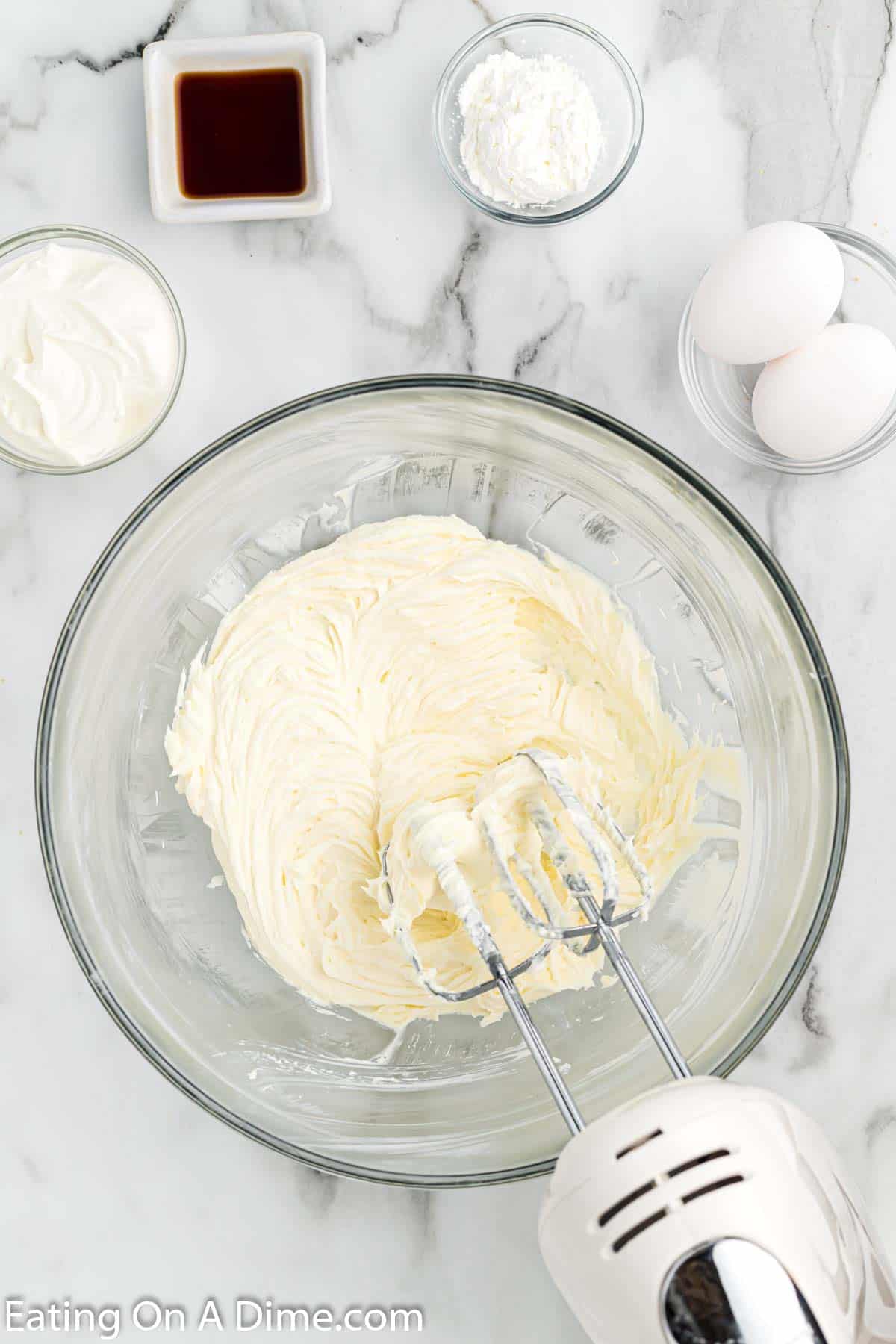 Beating the cream cheese and sugar together in a bowl