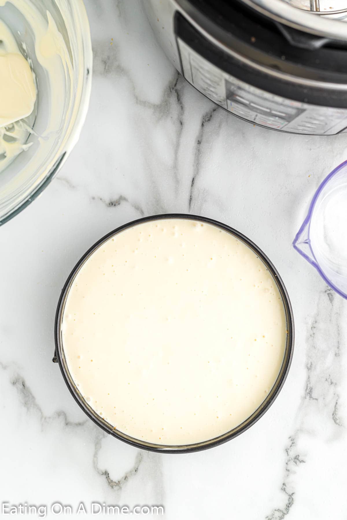 Pour the cheesecake mixture into the pan with the crust