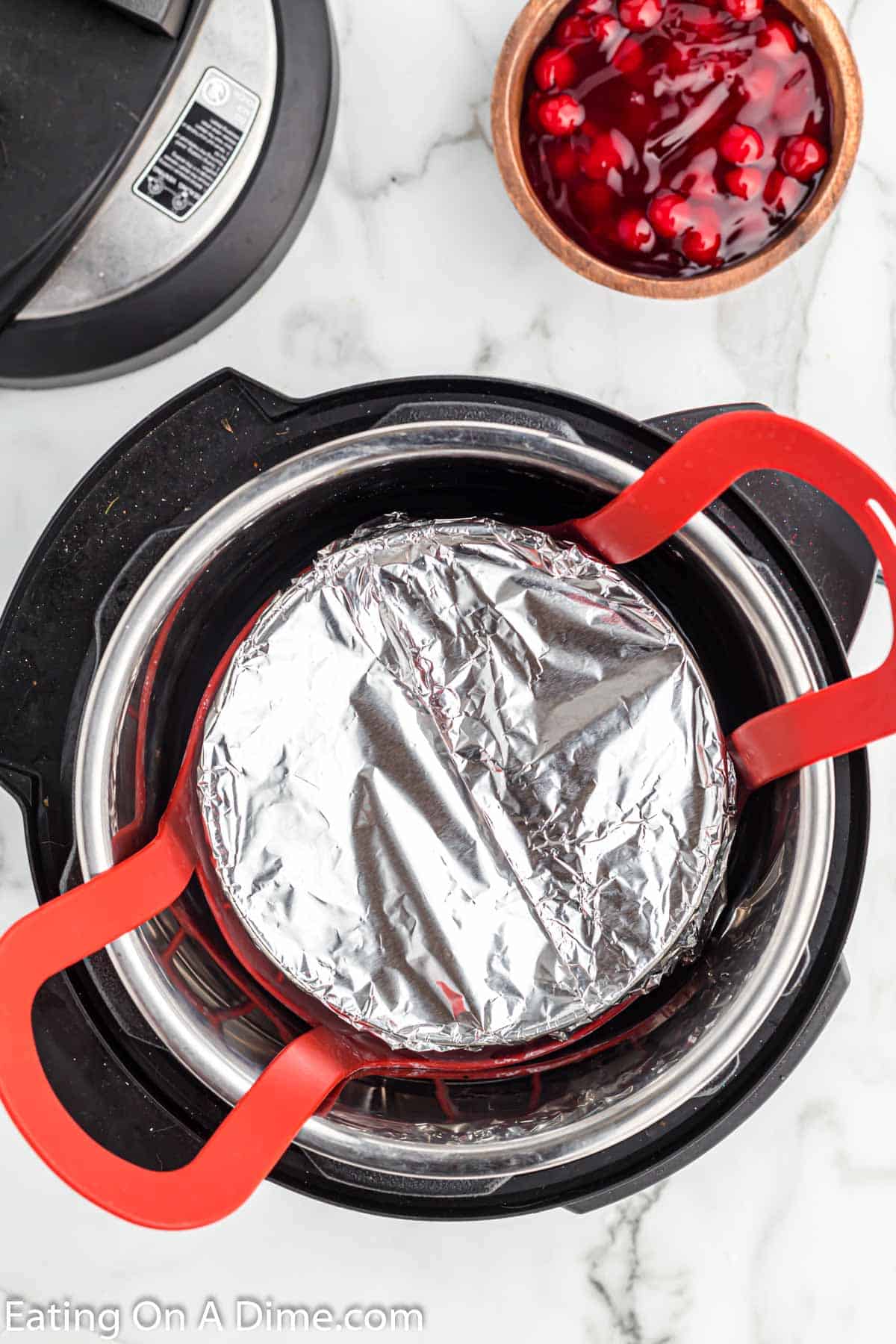 Placing the pan in the instant pot covered with foil 