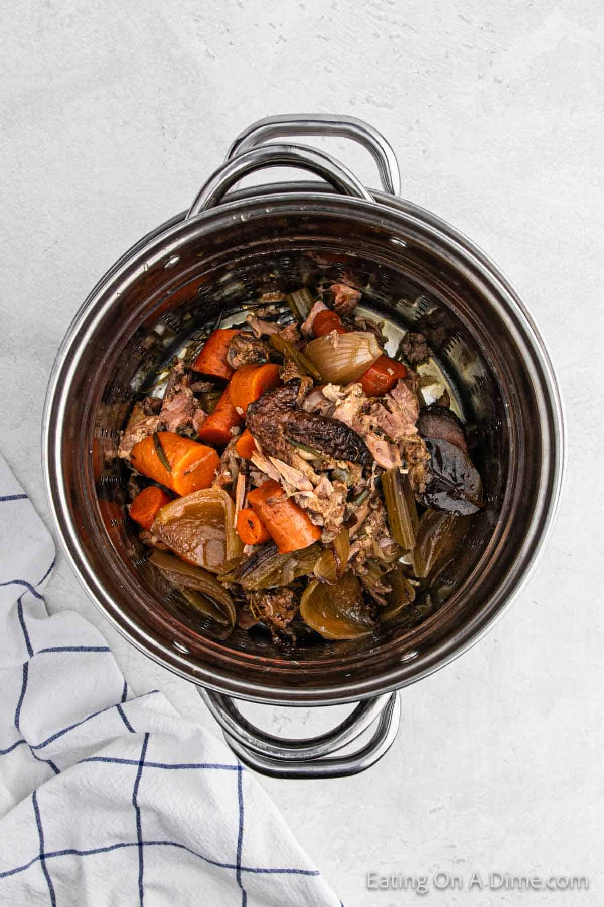 Cooked chicken and vegetables in a large pot