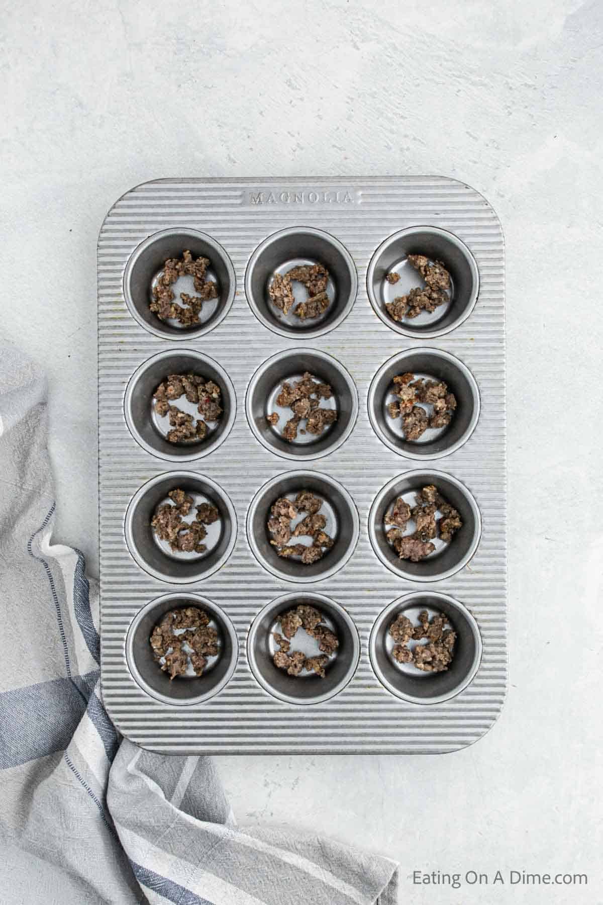 Sprinkle sausage crumbled in the muffin tin