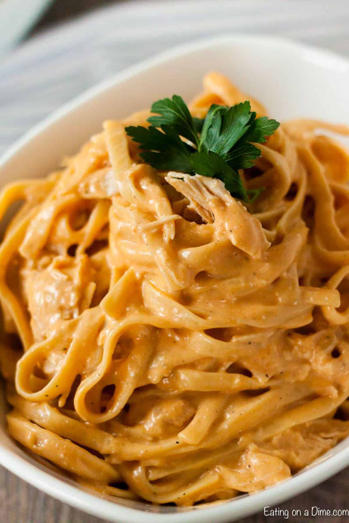 Creamy Buffalo Chicken pasta in a white bowl. 