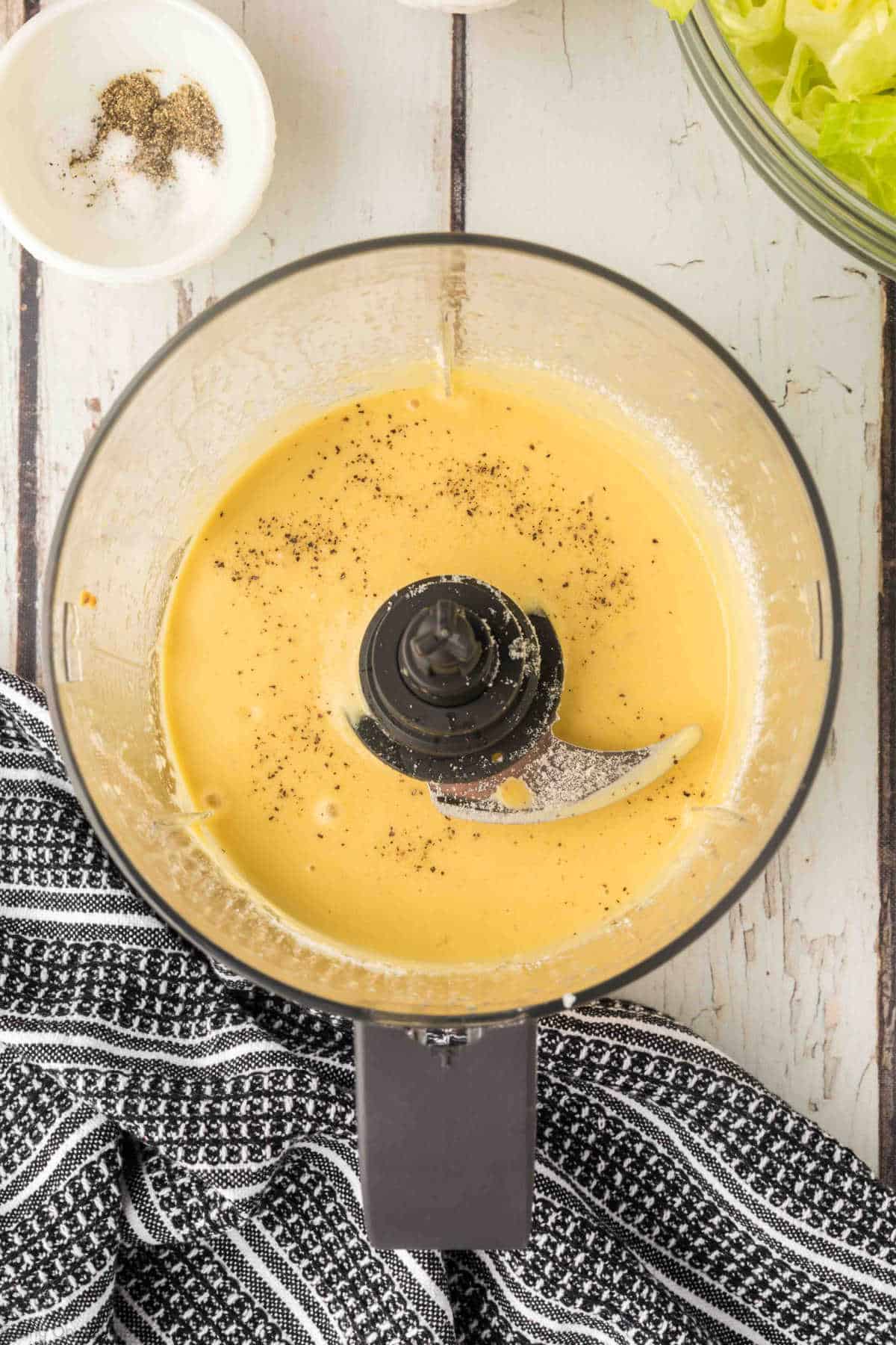 Blended caesar salad dressing in a food processor.