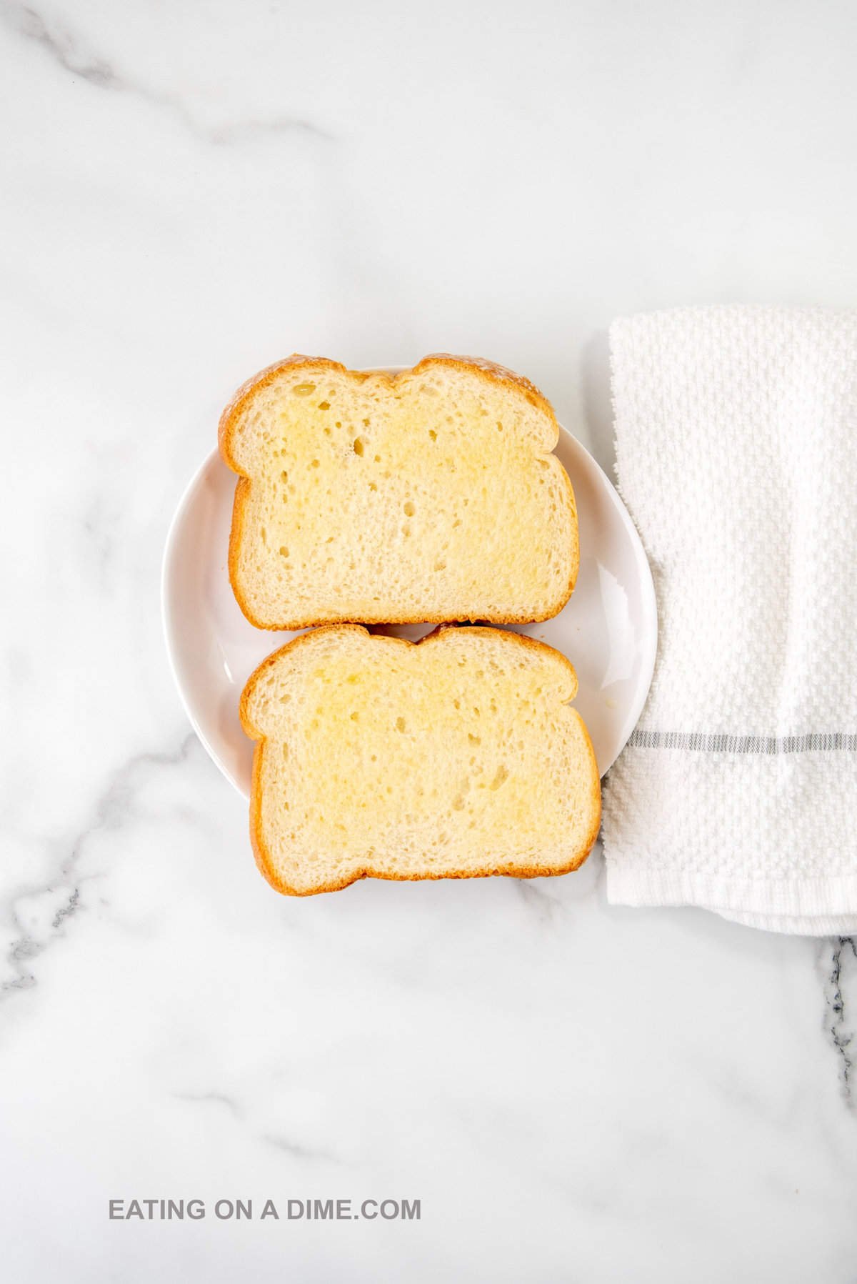 Buttering bread on a plate