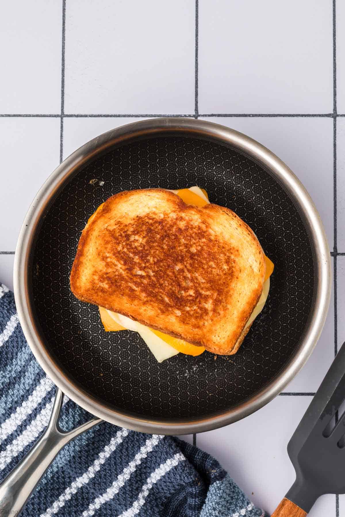 Cooked grilled cheese in a skillet