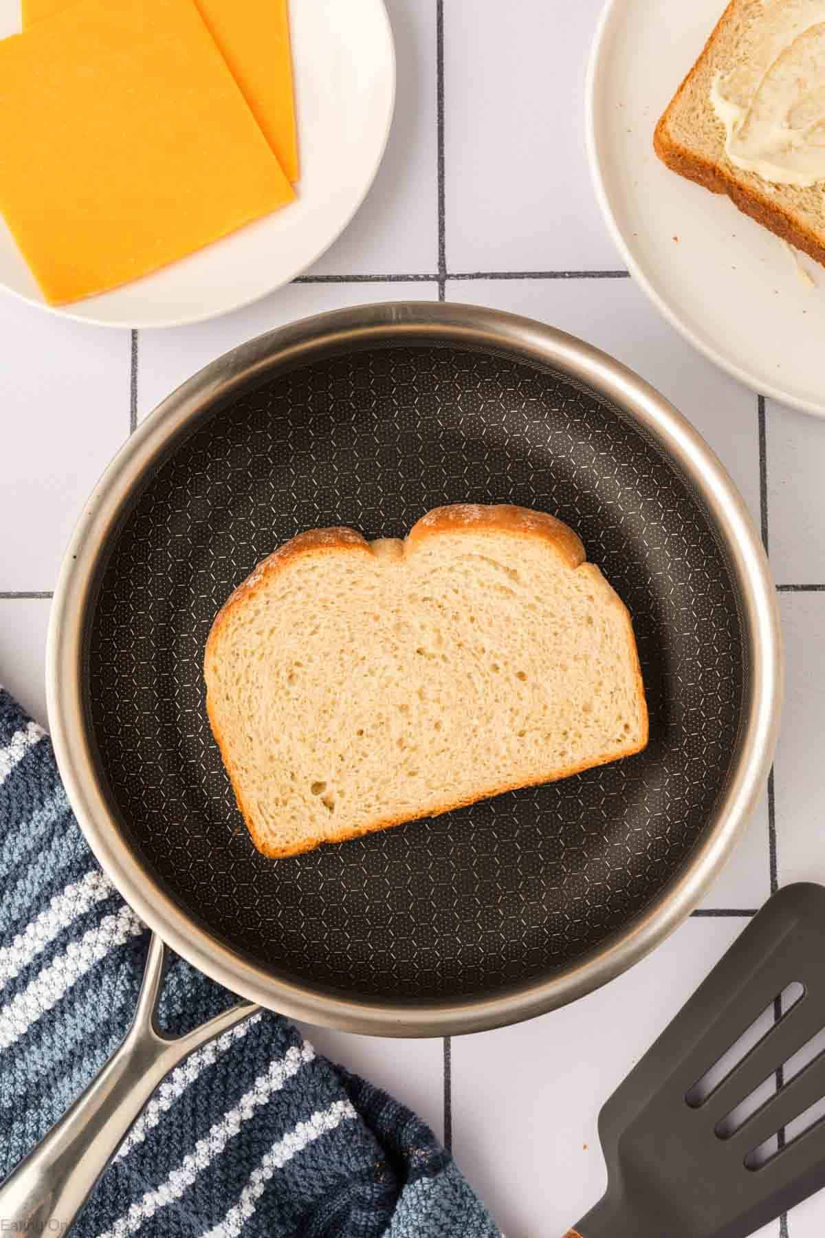 Place the butter bread on the heated skillet
