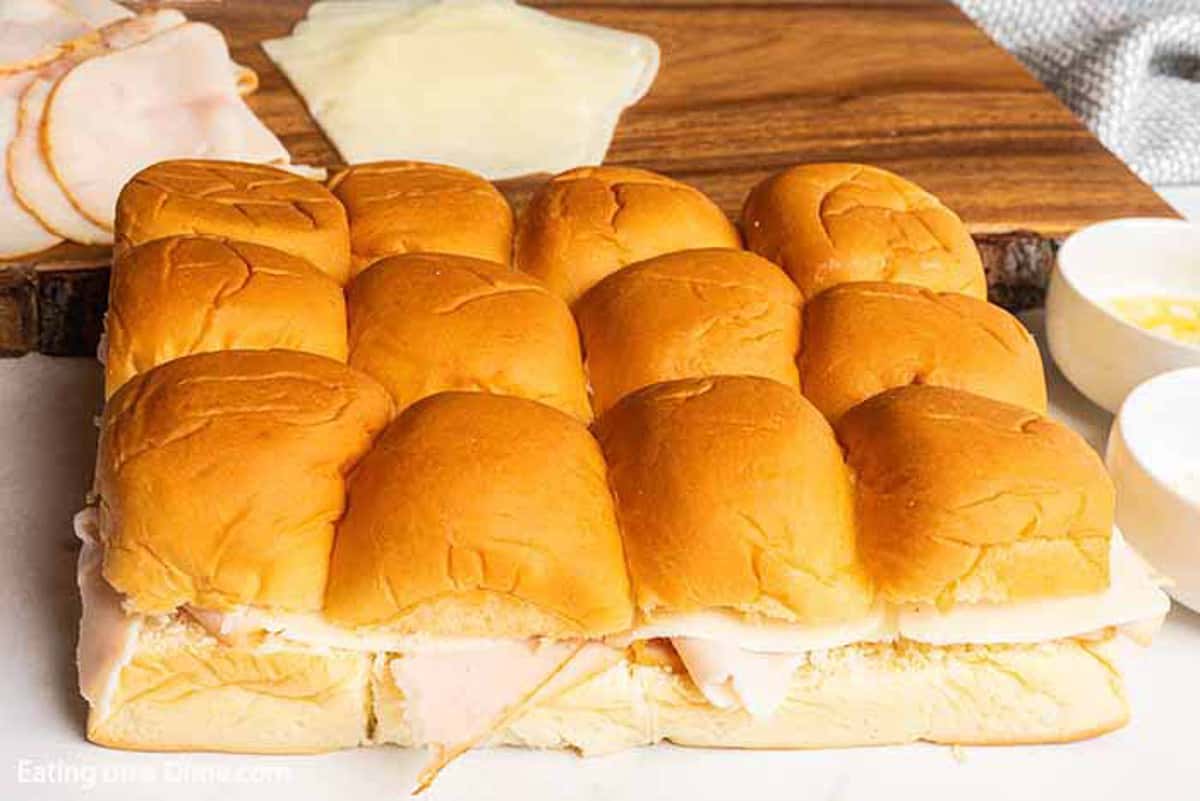 Hawaiian Rolls topped over deli turkey and slice cheese