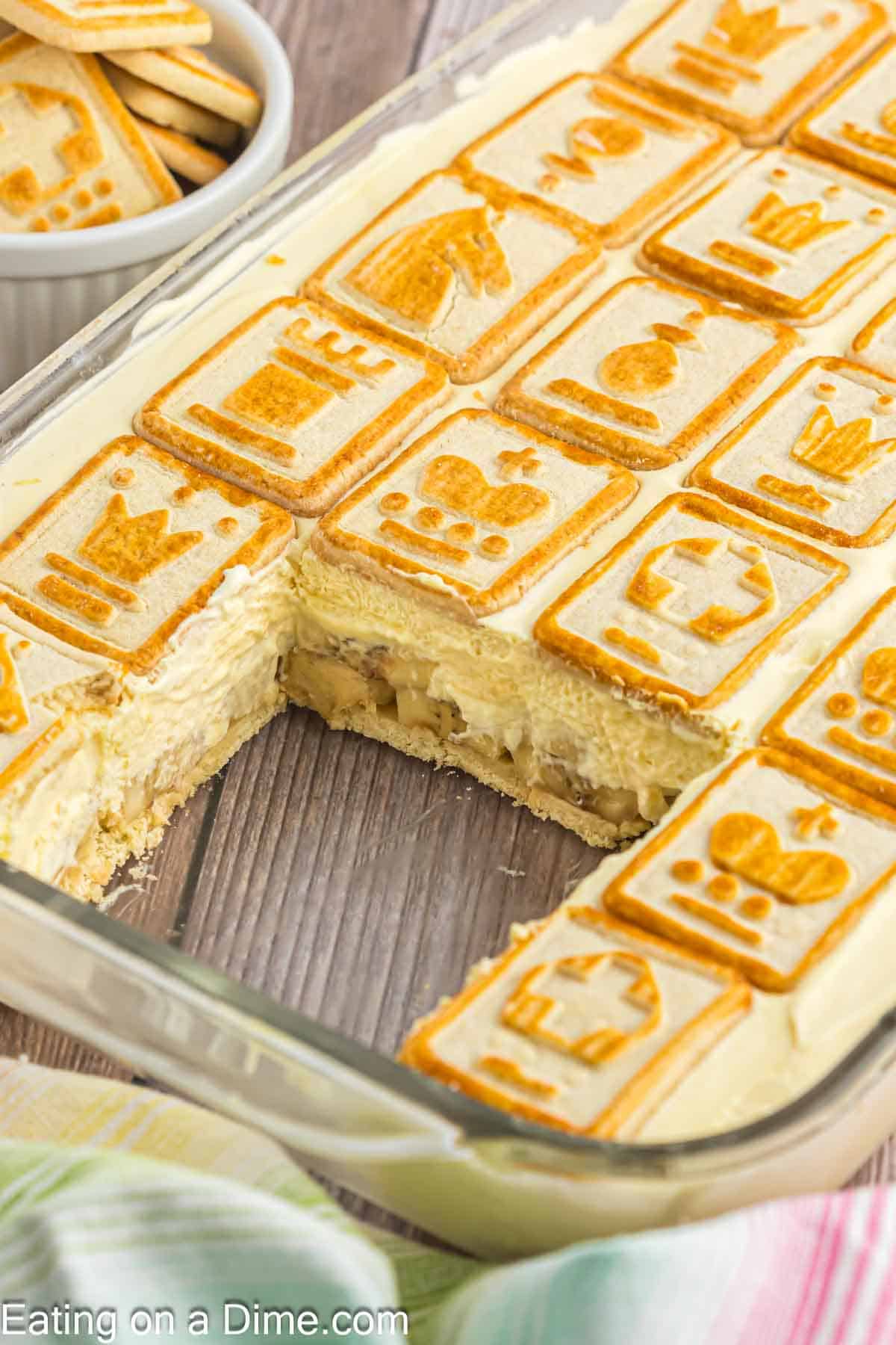 Close up image of banana pudding in the baking dish with a slice missing