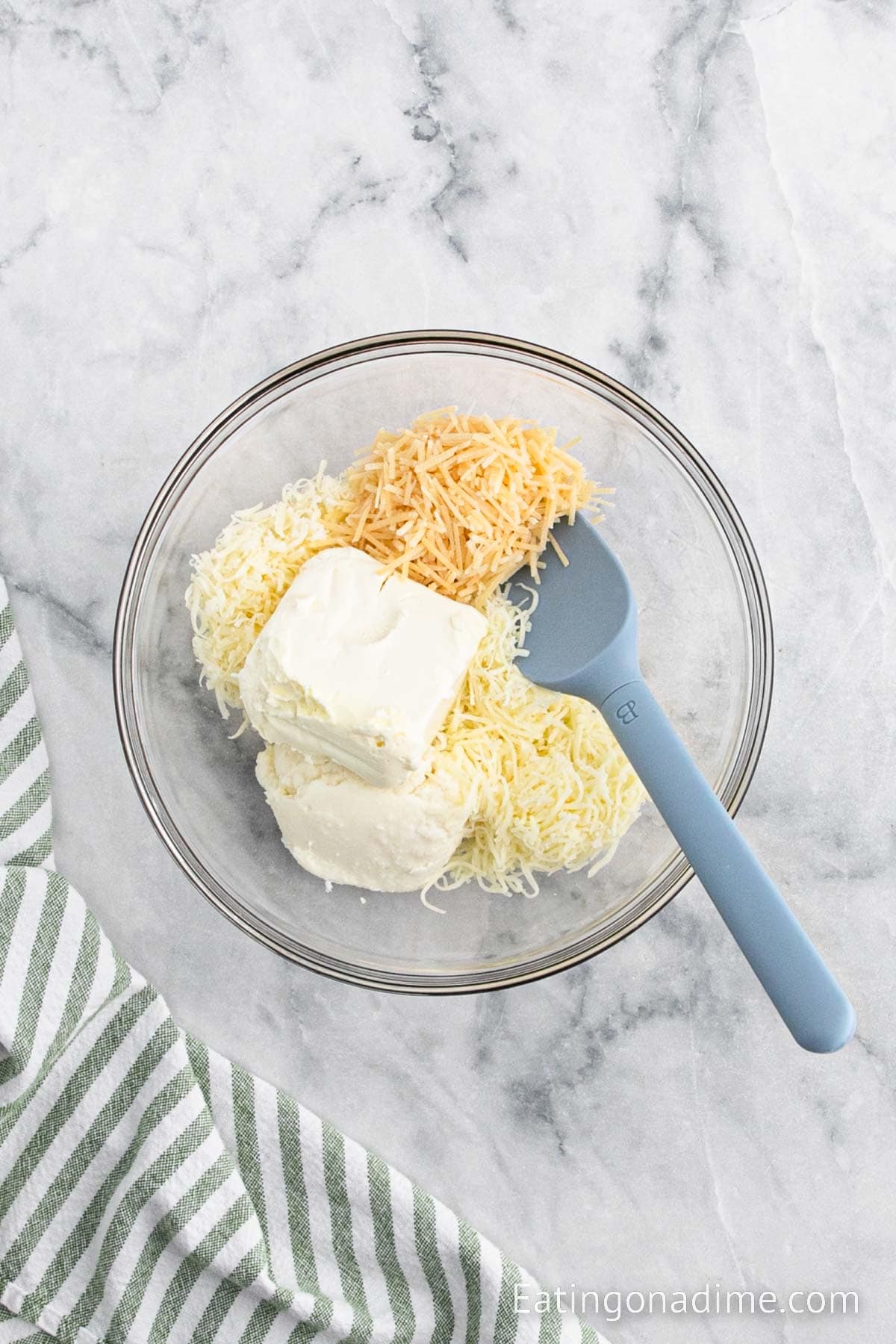 Combining the cheese together in a bowl