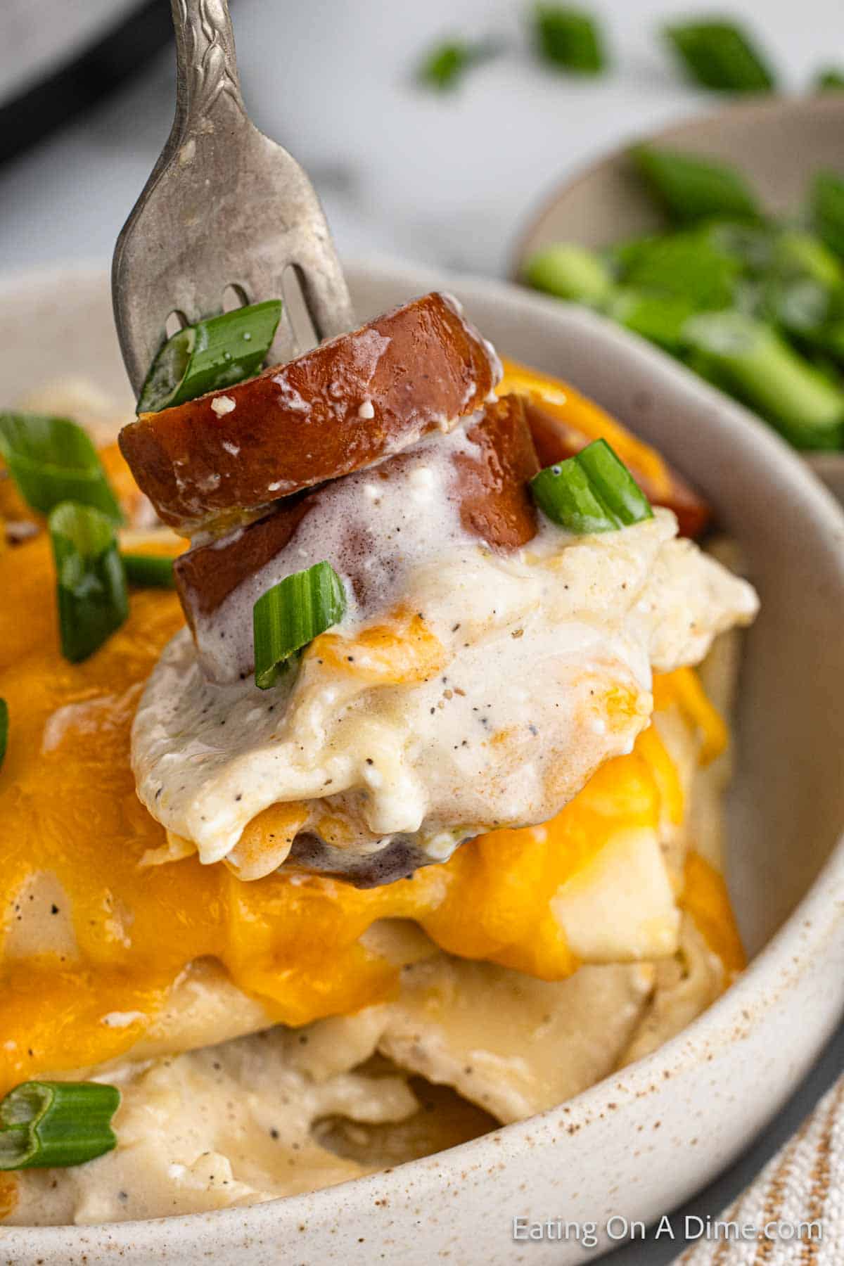 Close up image of a serving of pierogi casserole on a fork
