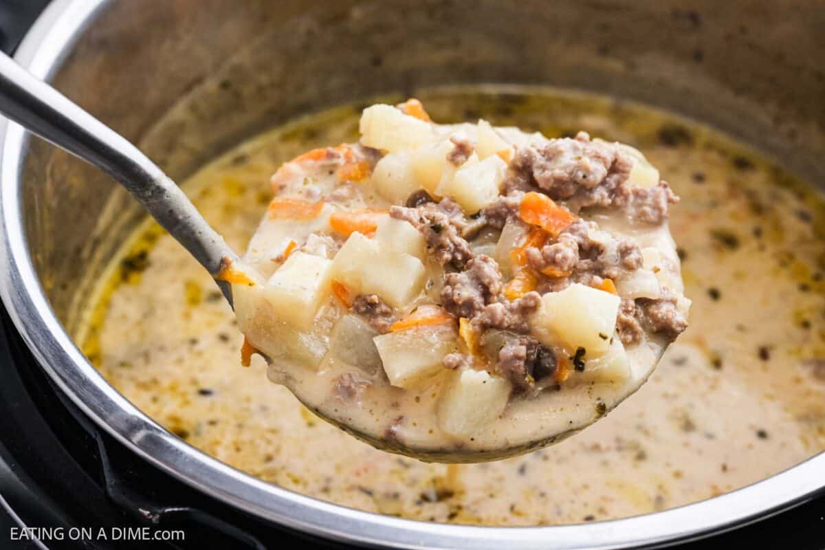 A serving of cheeseburger soup on a ladle, served out of the Instant Pot. 