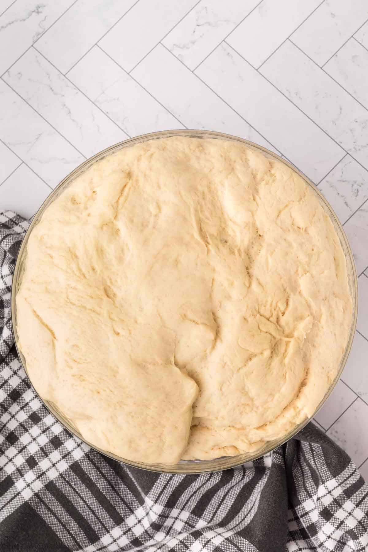 Allowing the dough to double in size in a bowl