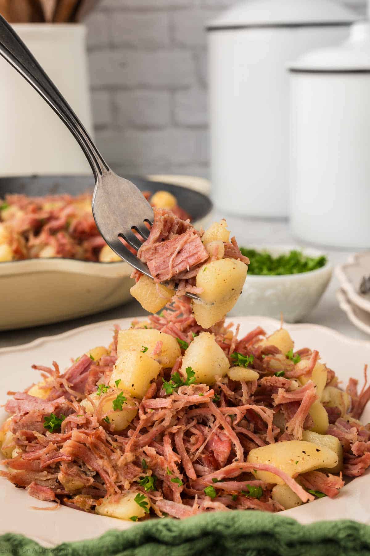 Close up image of corned beef on a plate with a serving on a fork