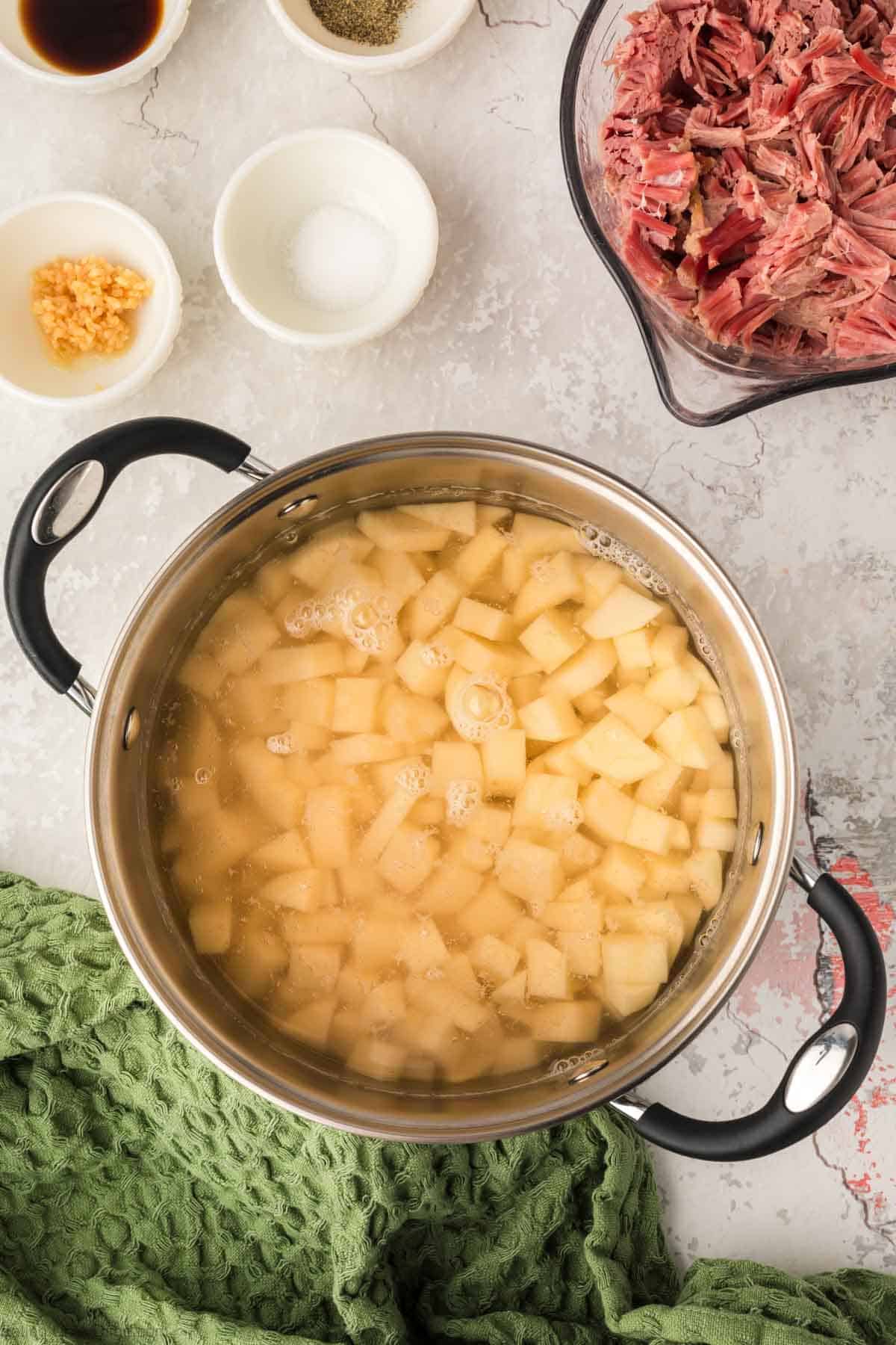 Boiling diced potatoes in a large pot