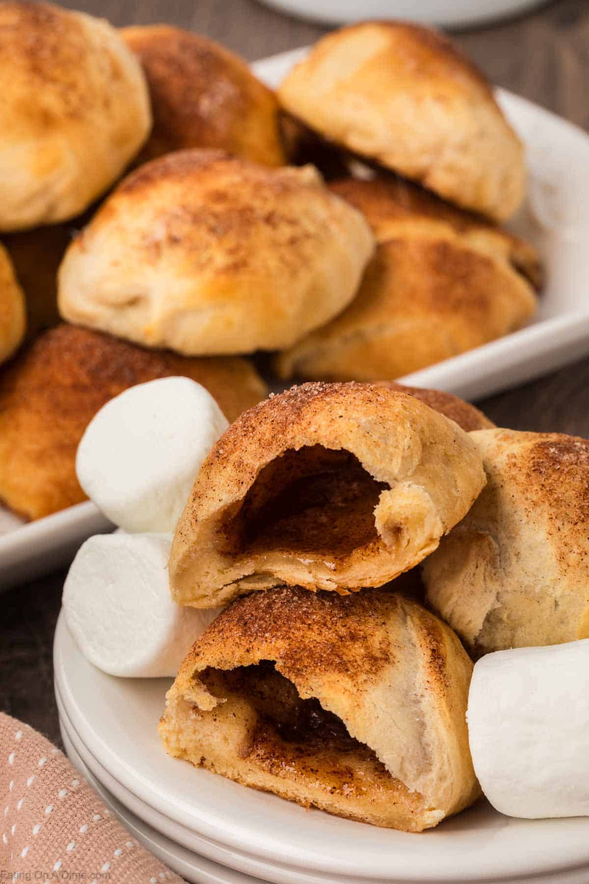 Close up image of empty tomb rolls stacked on a plate with marshmallows