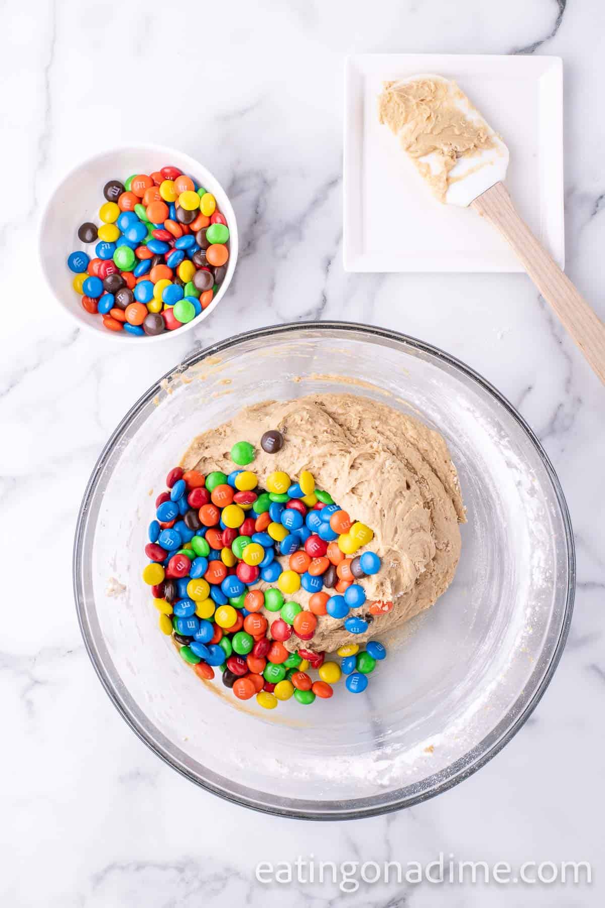 Stir in M&M Candies into the cookie batter in a bowl