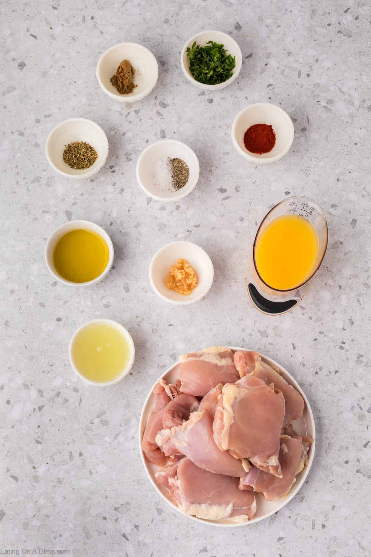 Mojo Chicken Ingredients - chicken thighs, orange juice, lime, garlic, olive oil, cilantro, oregano, cumin, paprika, salt, pepper