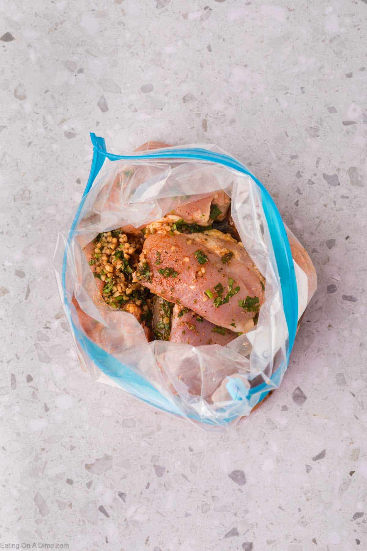 Marinade poured over the chicken thighs in a ziplock bag
