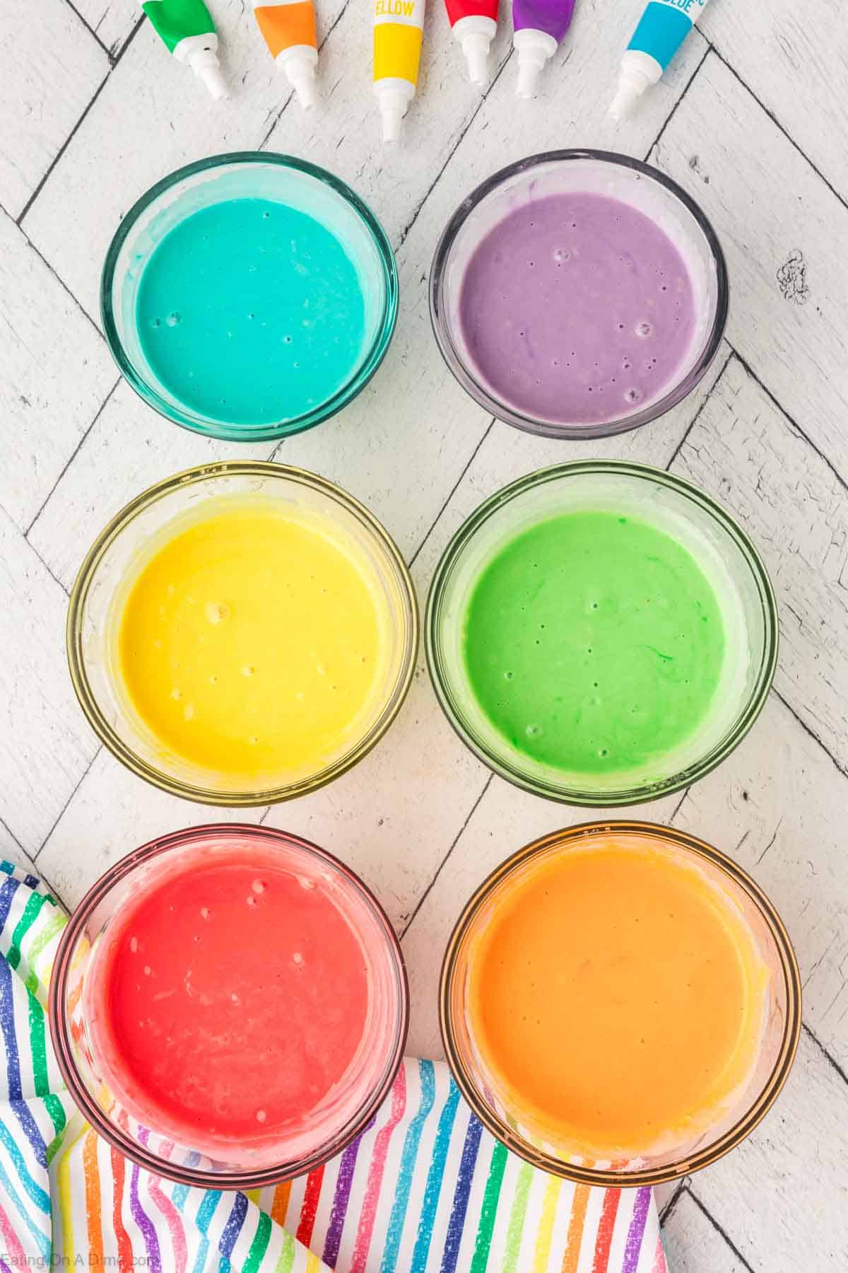 Adding food color to the pancake batter in the 6 bowls