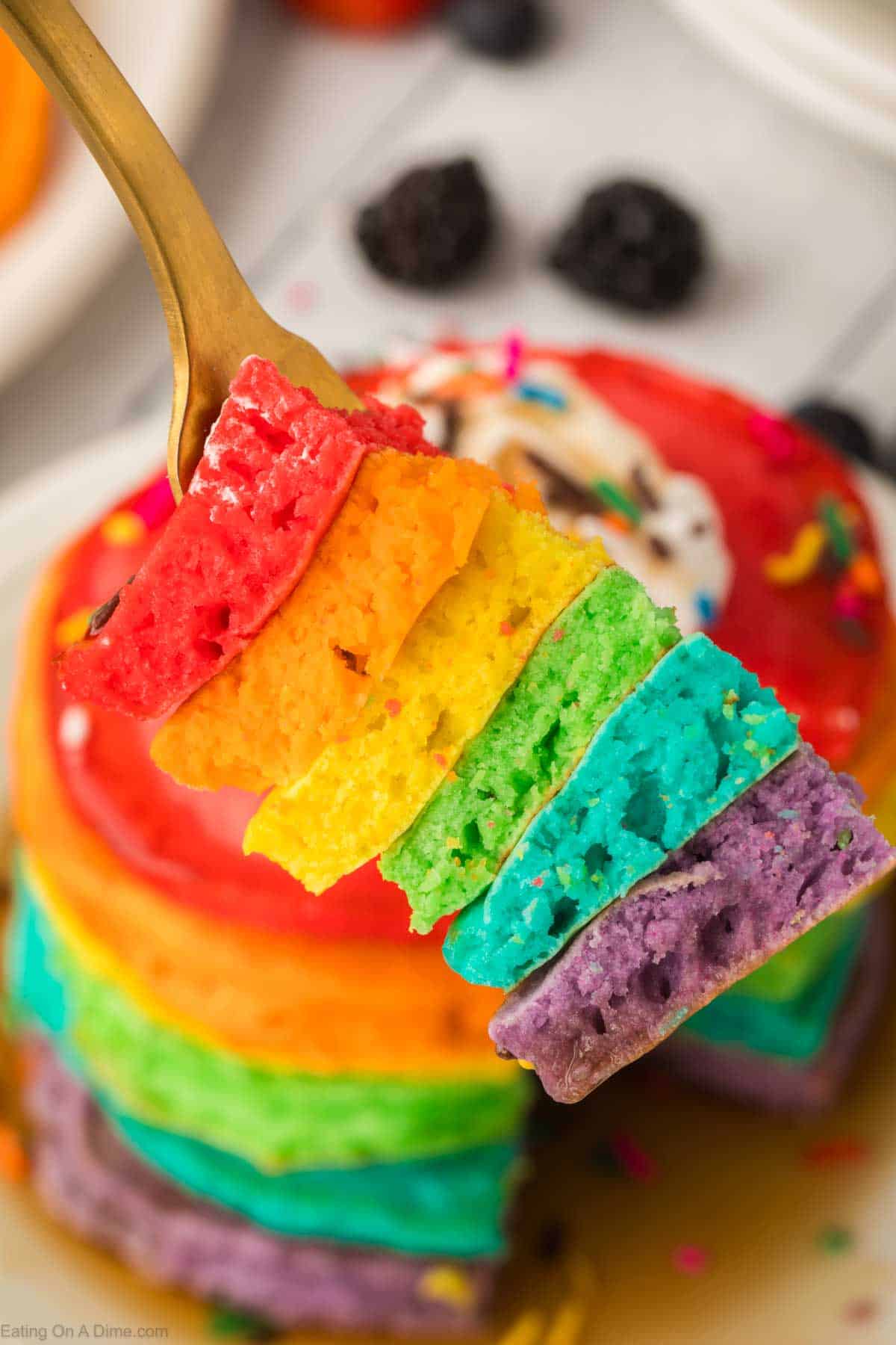 Close up image of a bite of the rainbow pancakes on a fork