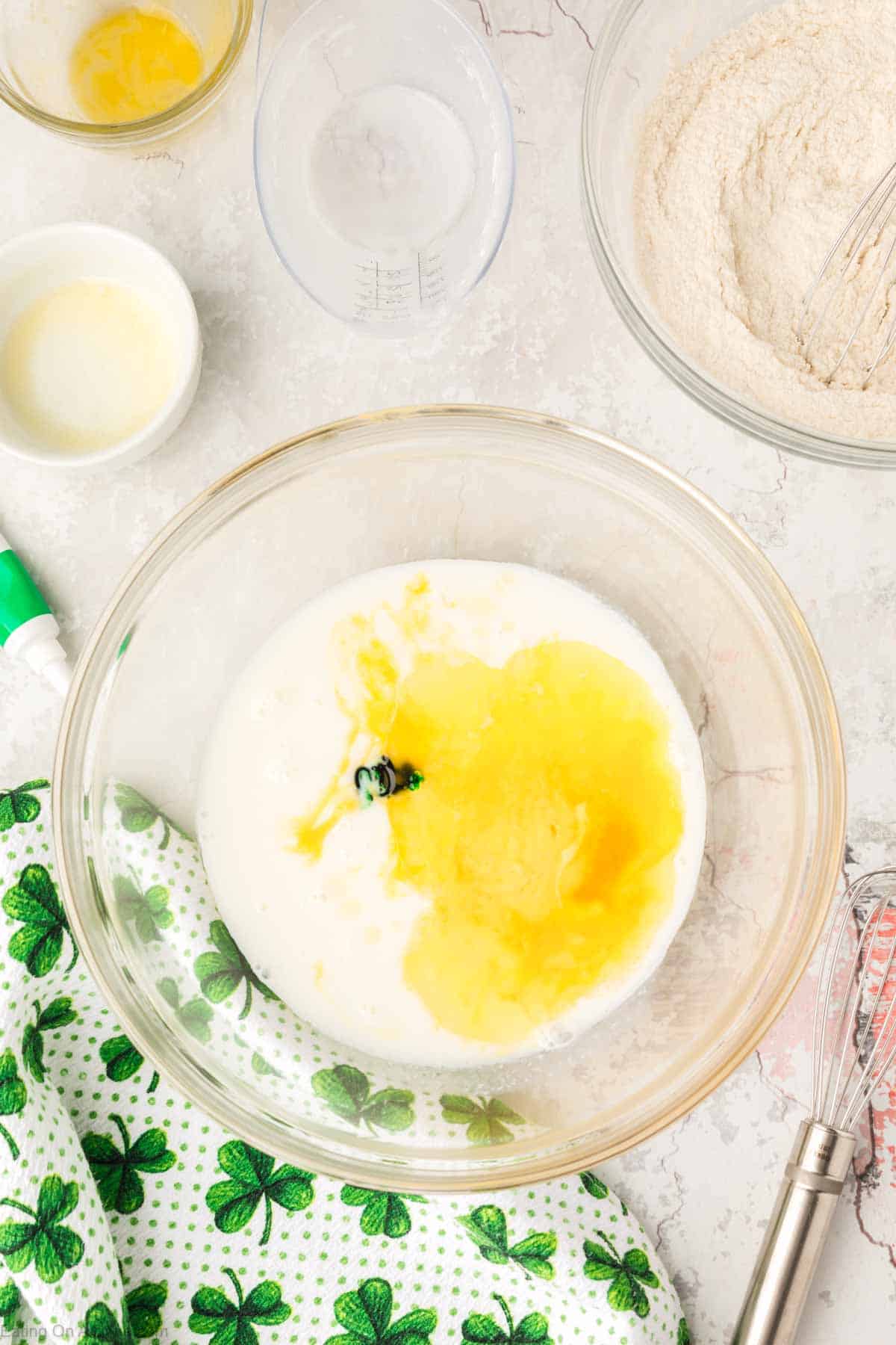 Combining the buttermilk, egg, butter, and green food coloring