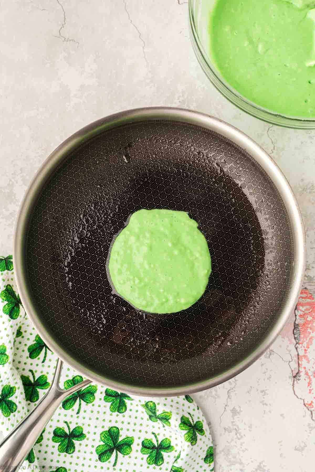 Pouring green batter in the skillet