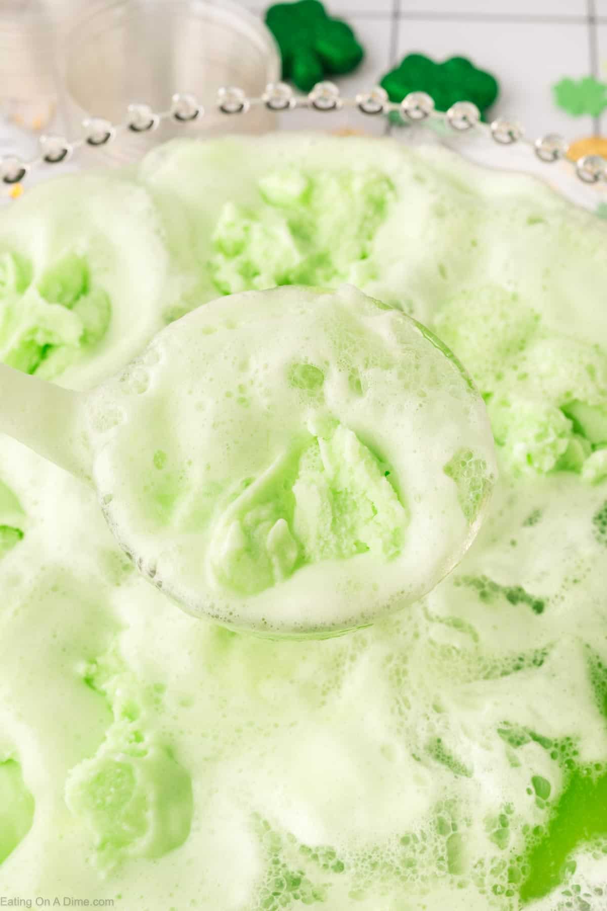 Close up image of green punch in a punch bowl