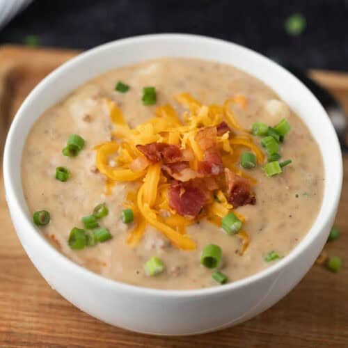 Bowl of Instant Pot Cheeseburger Soup topped with cheese.