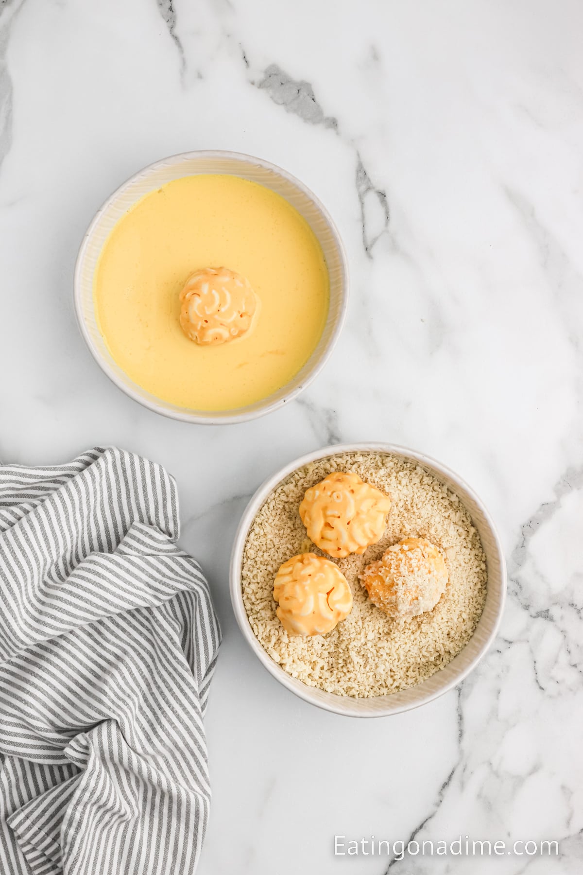 Rolling the cheese balls in the egg mixture and breadcrumbs